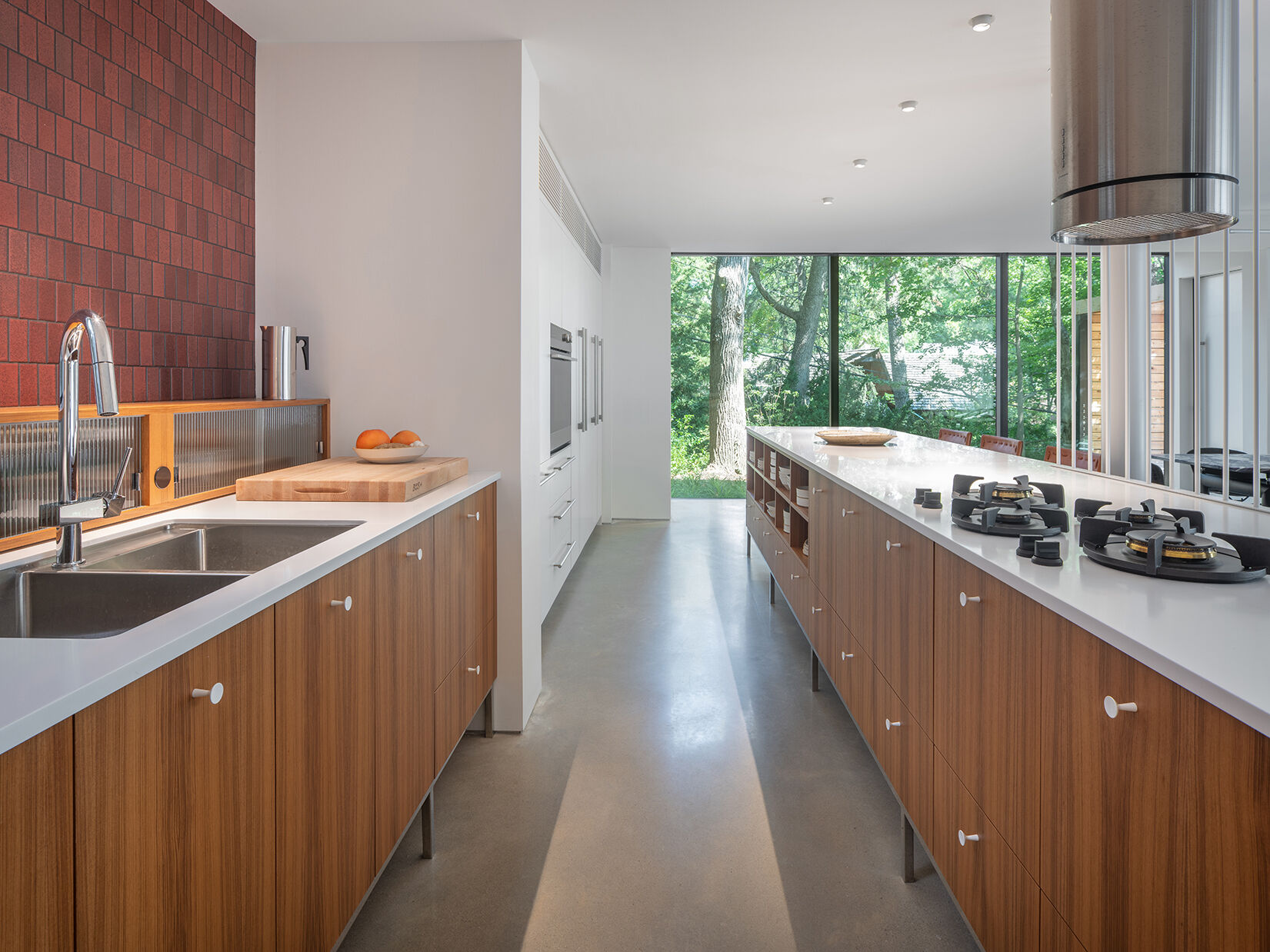 In this mid-century modern inspired kitchen, clean lines and a furniture-like design keep the space open while still providing full functionality.