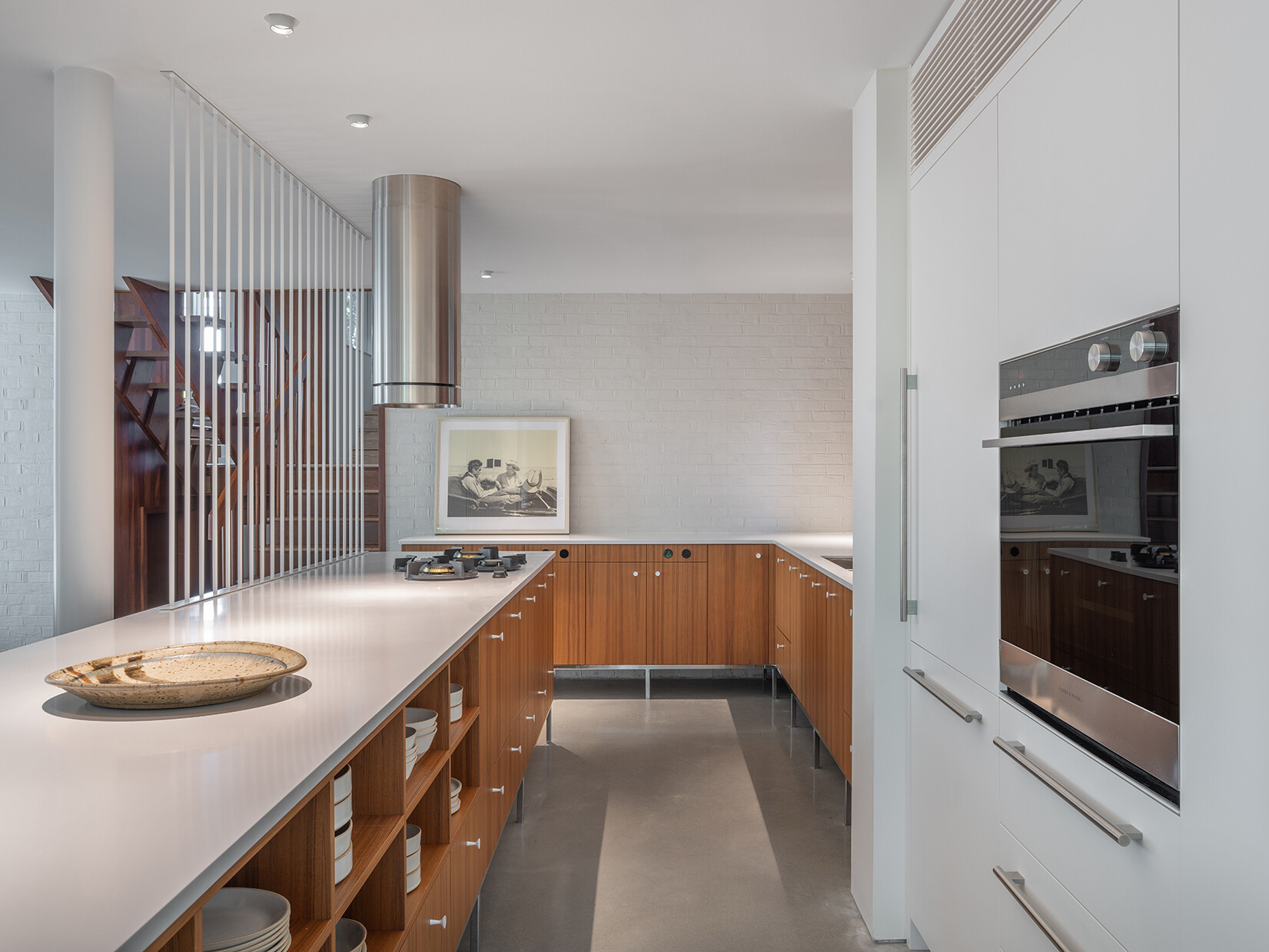 In this mid-century modern inspired kitchen, clean lines and a furniture-like design keep the space open while still providing full functionality.