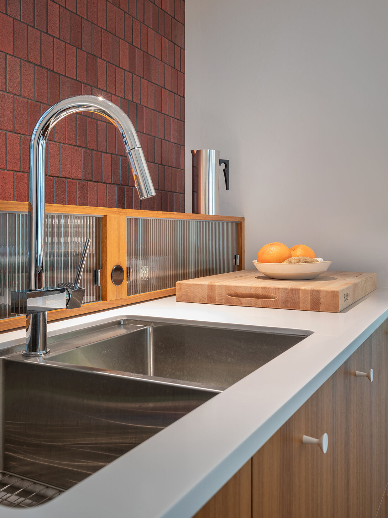 In this mid-century modern inspired kitchen, clean lines and a furniture-like design keep the space open while still providing full functionality.