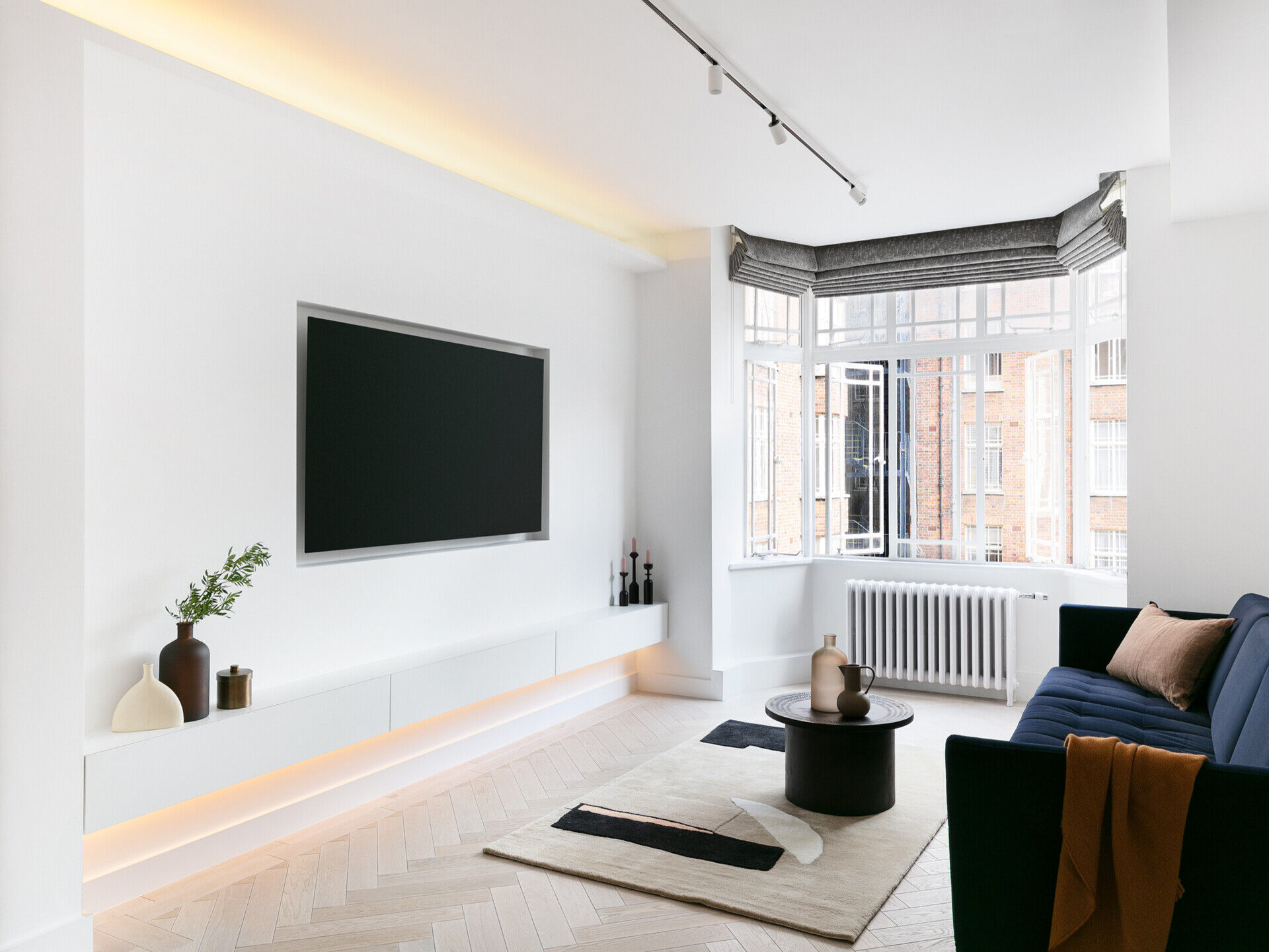 Concealed LED lighting creates a soft, continuous glow across this modern London living space.
