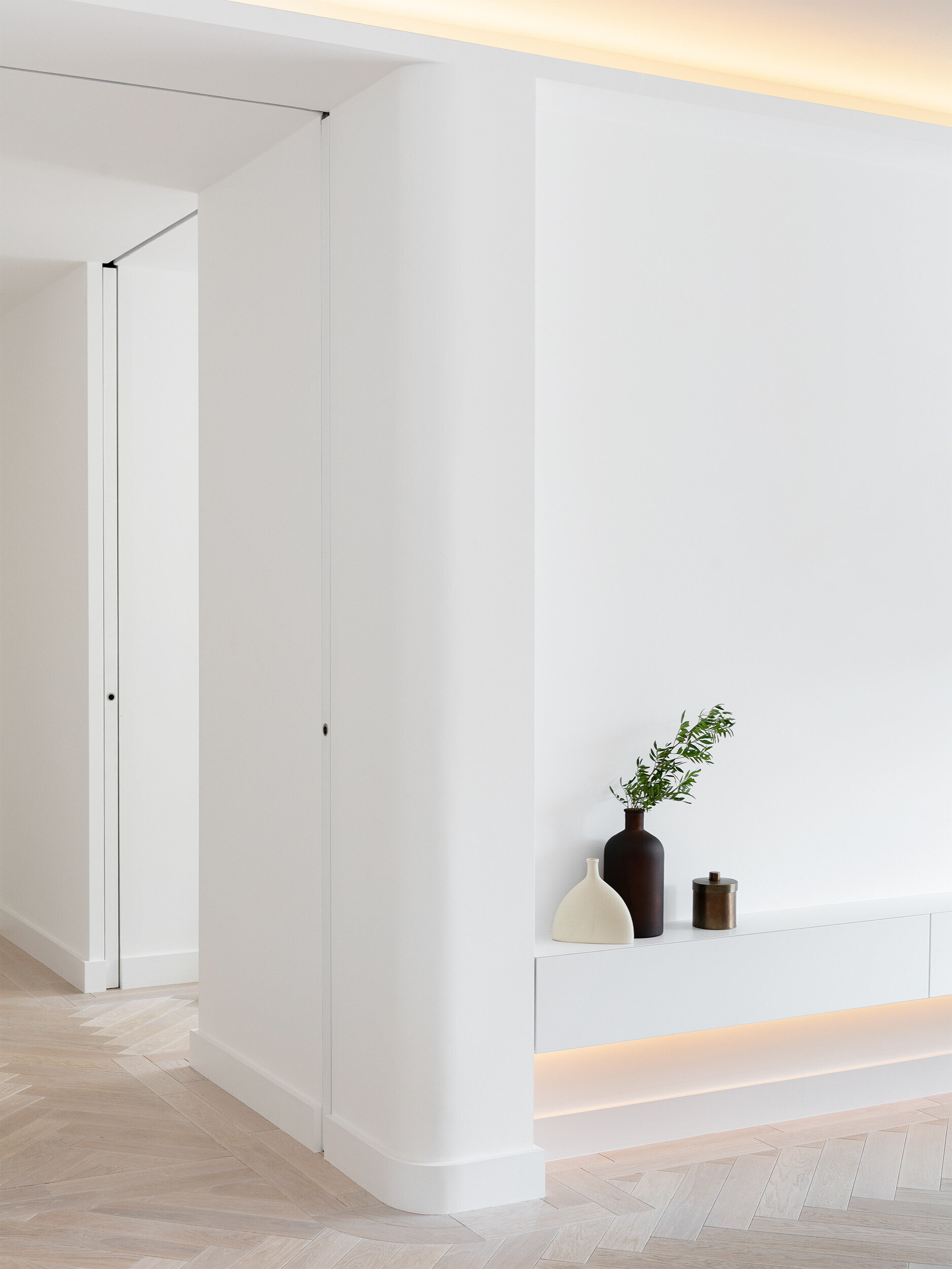 Concealed LED lighting creates a soft, continuous glow across this modern London living space.