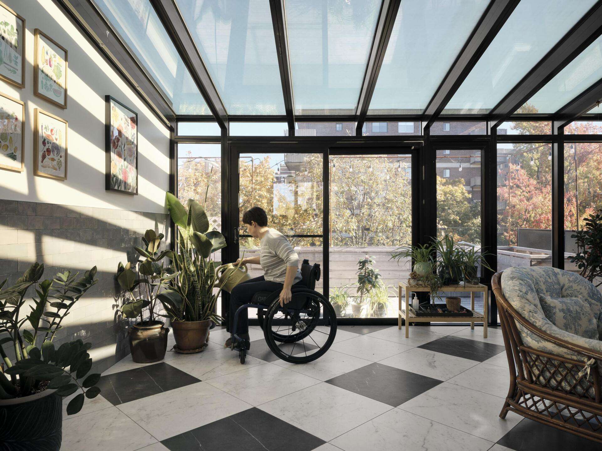 Within the extension, slatted elements filter natural light, creating a soft interplay of brightness and shadow. These features maintain privacy while adding depth to the interior spaces, while a sunroom provides a relaxed space for enjoying the natural light.