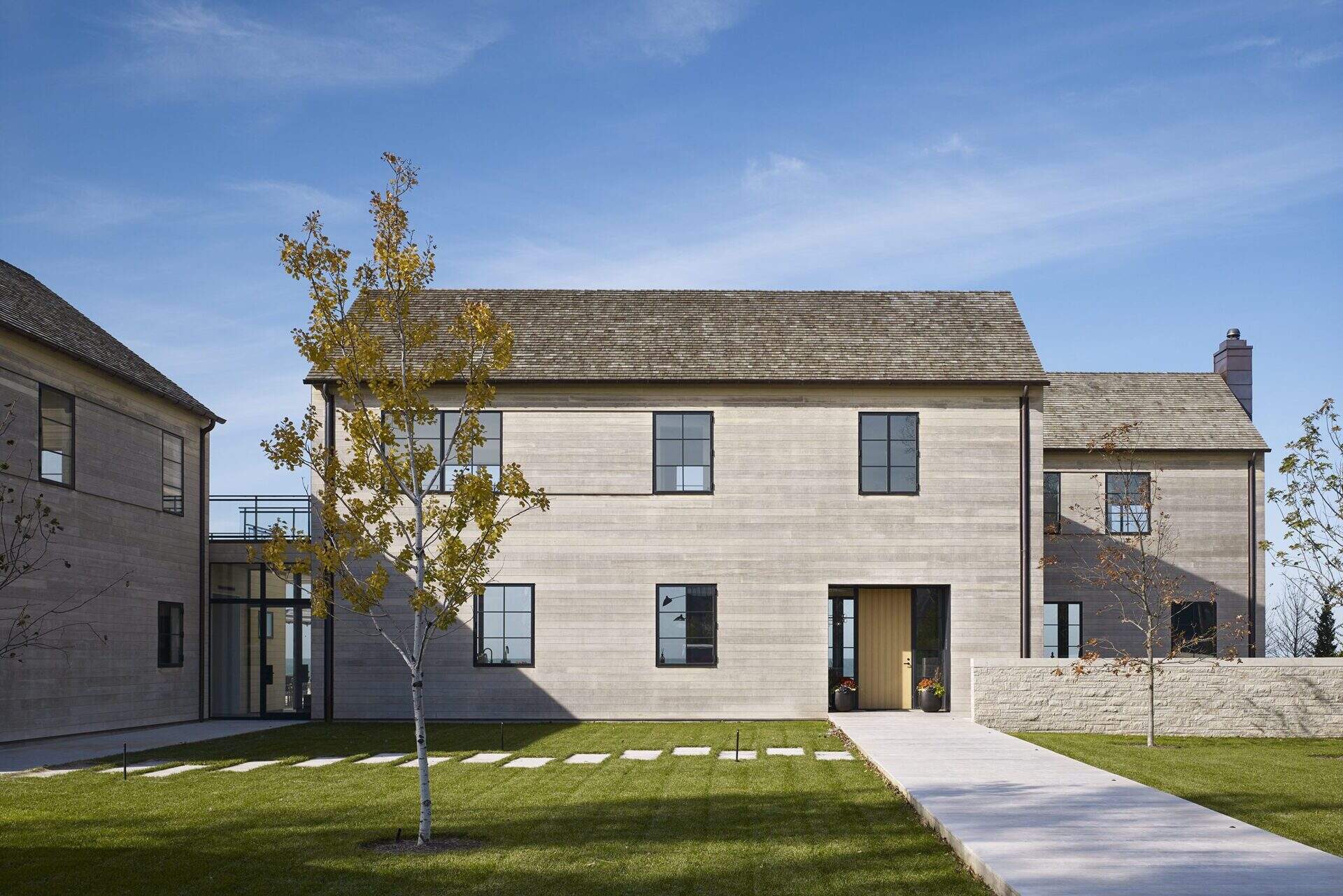 This modern house features Accoya wood siding and cedar shingles that create a durable, weather-ready exterior designed for life by the lake.