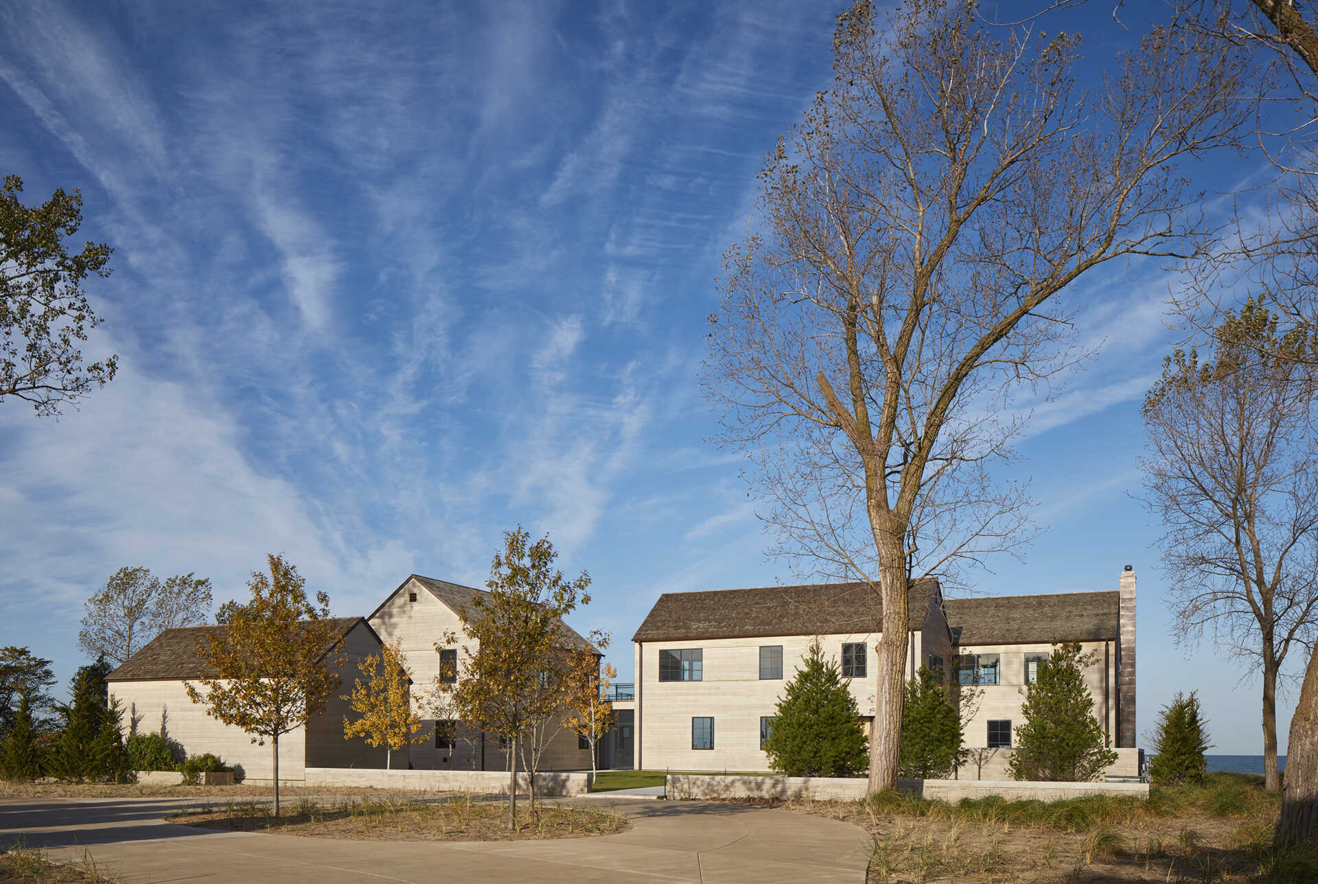 This modern house features Accoya wood siding and cedar shingles that create a durable, weather-ready exterior designed for life by the lake.