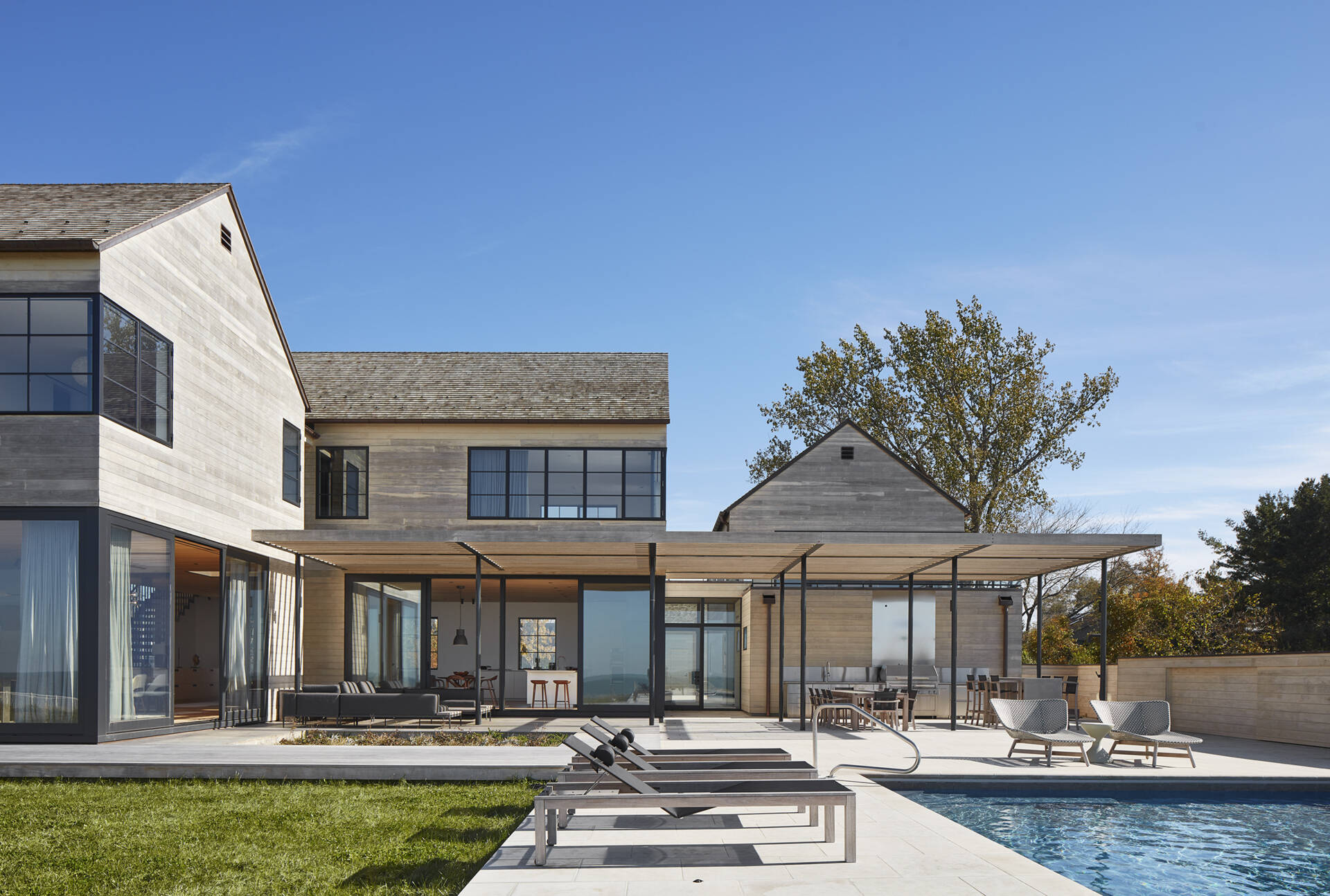 This modern house features Accoya wood siding and cedar shingles that create a durable, weather-ready exterior designed for life by the lake.