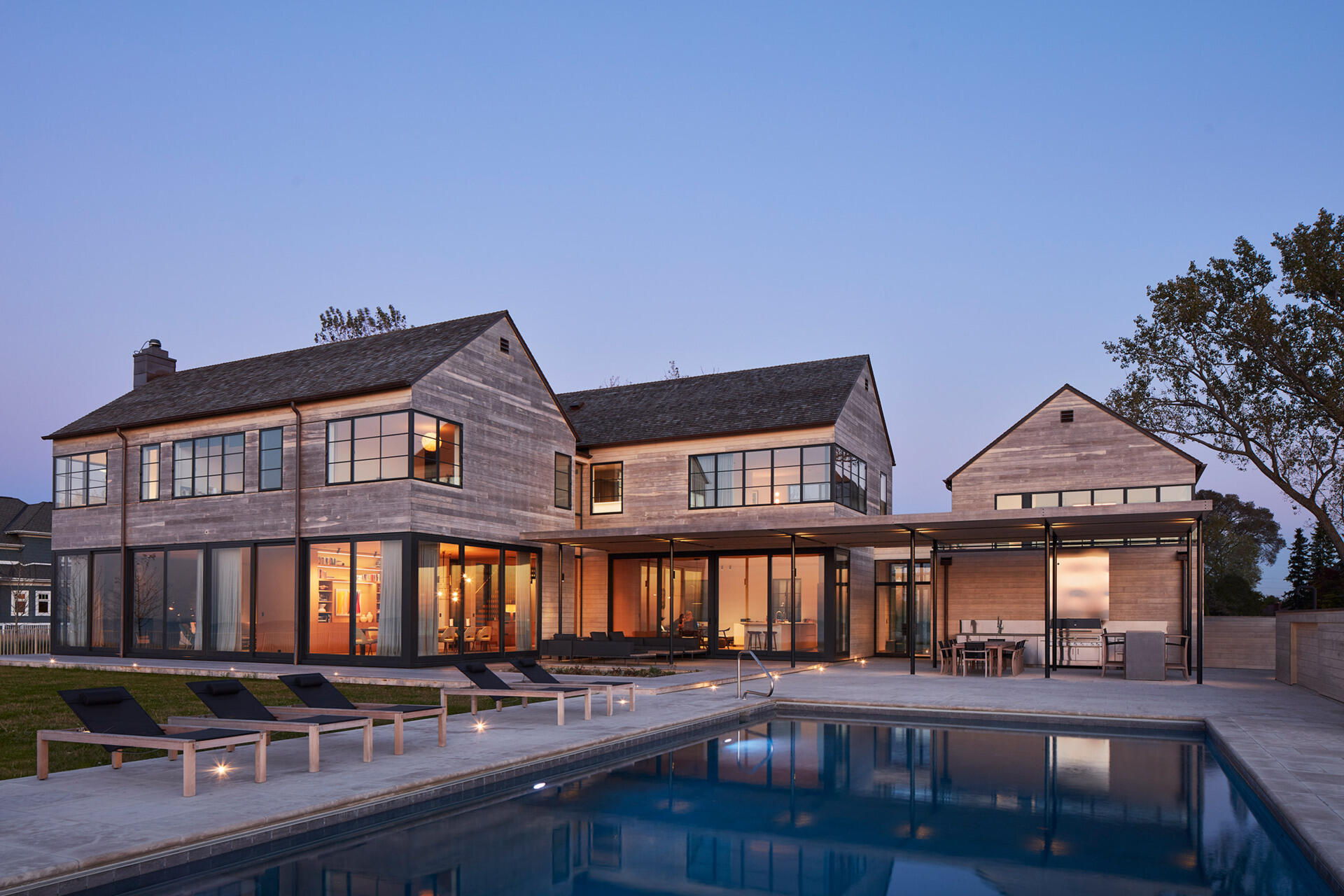This modern house features Accoya wood siding and cedar shingles that create a durable, weather-ready exterior designed for life by the lake.