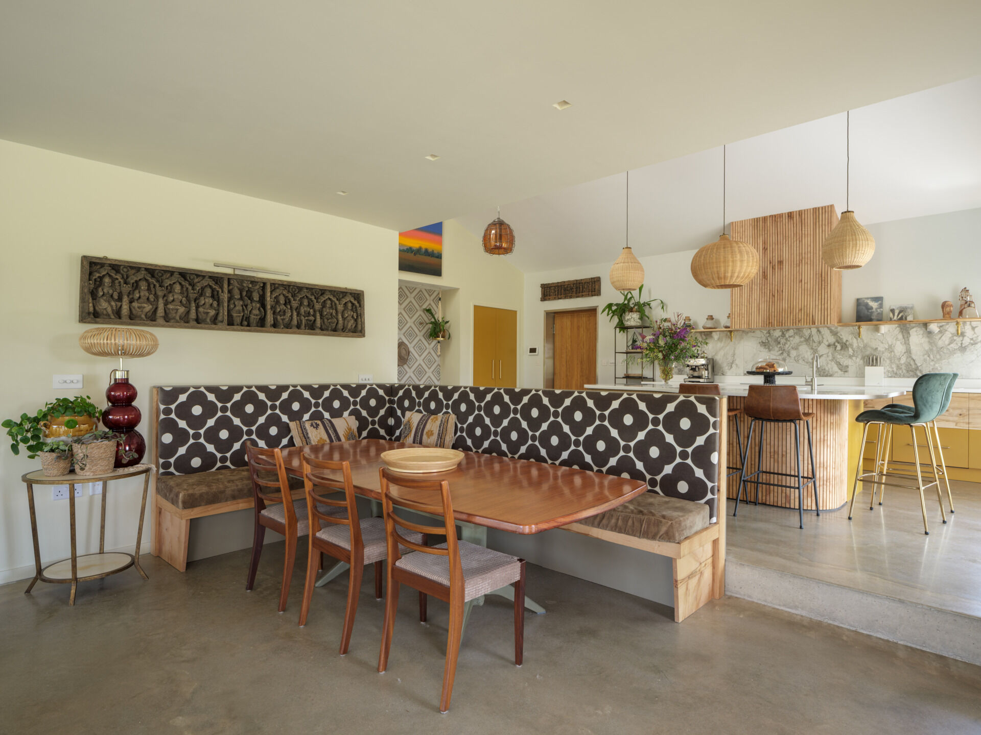 The dining area is positioned to take advantage of both light and views, with a built-in corner banquette that maximizes seating while keeping the layout efficient. This detail adds a sense of permanence to the space and supports everyday use, making it both functional and visually integrated into the overall design.