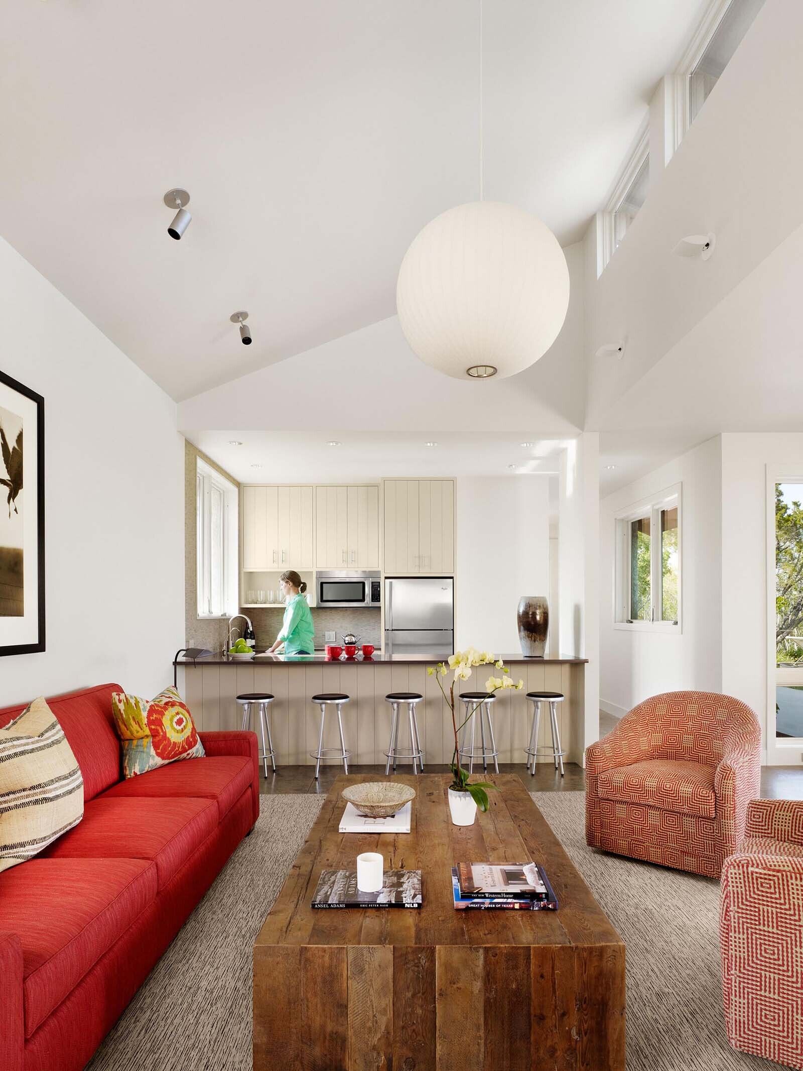 A limestone guest house by the pool features an open-plan layout with two bedrooms, offering a private yet connected space for visitors.