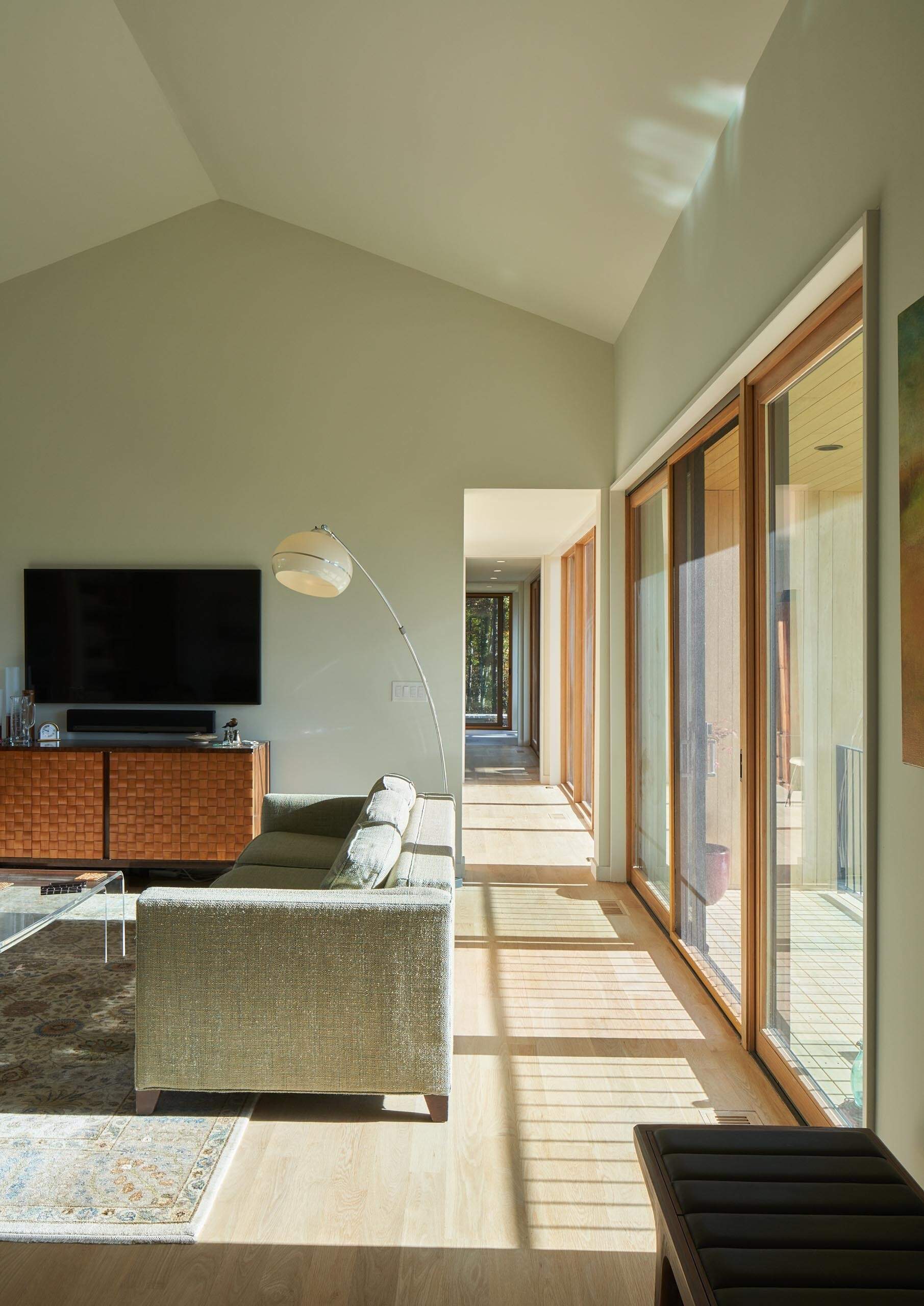 A vaulted ceiling and open-plan layout make the living and dining area feel bright, open, and expansive.