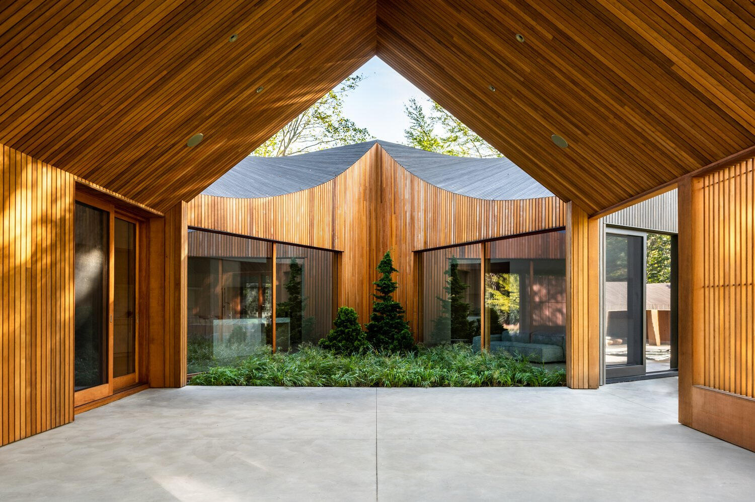 Warm cedar cladding softens the transition between indoors and outdoors, adding contrast to the home’s dark exterior.