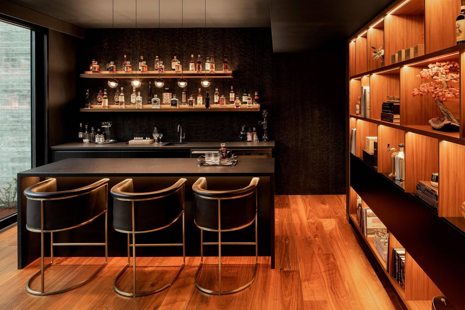 A modern home with a hidden whiskey room behind a bookshelf and a full entertainment wing including a gym, sauna, and media room.