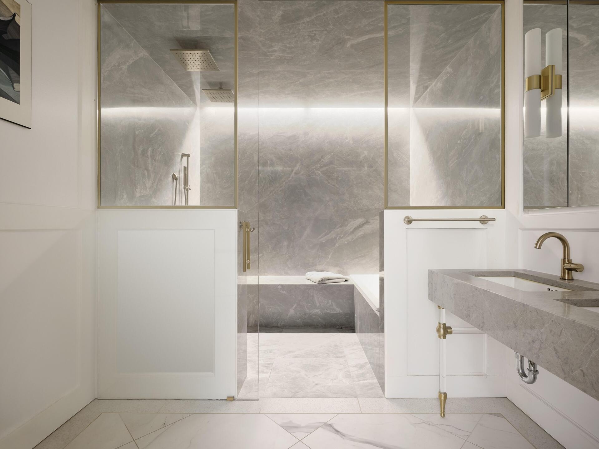 Curbless shower, built-in benches, and sleek grab bars create a bathroom that is both functional and accessible.