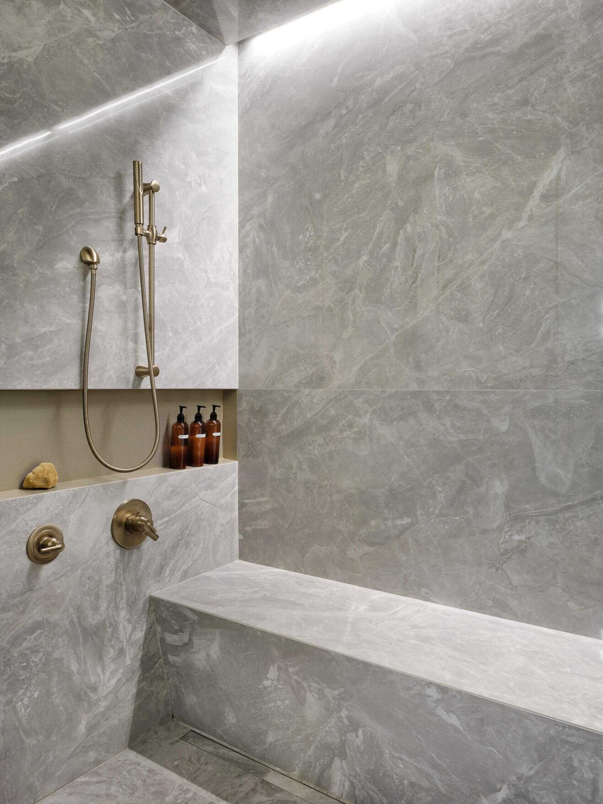 Curbless shower, built-in benches, and sleek grab bars create a bathroom that is both functional and accessible.