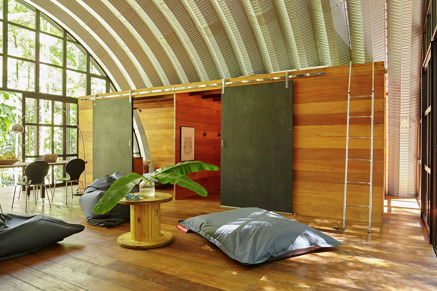 The curved roof design flows across every room, creating a unified interior with a strong architectural identity.