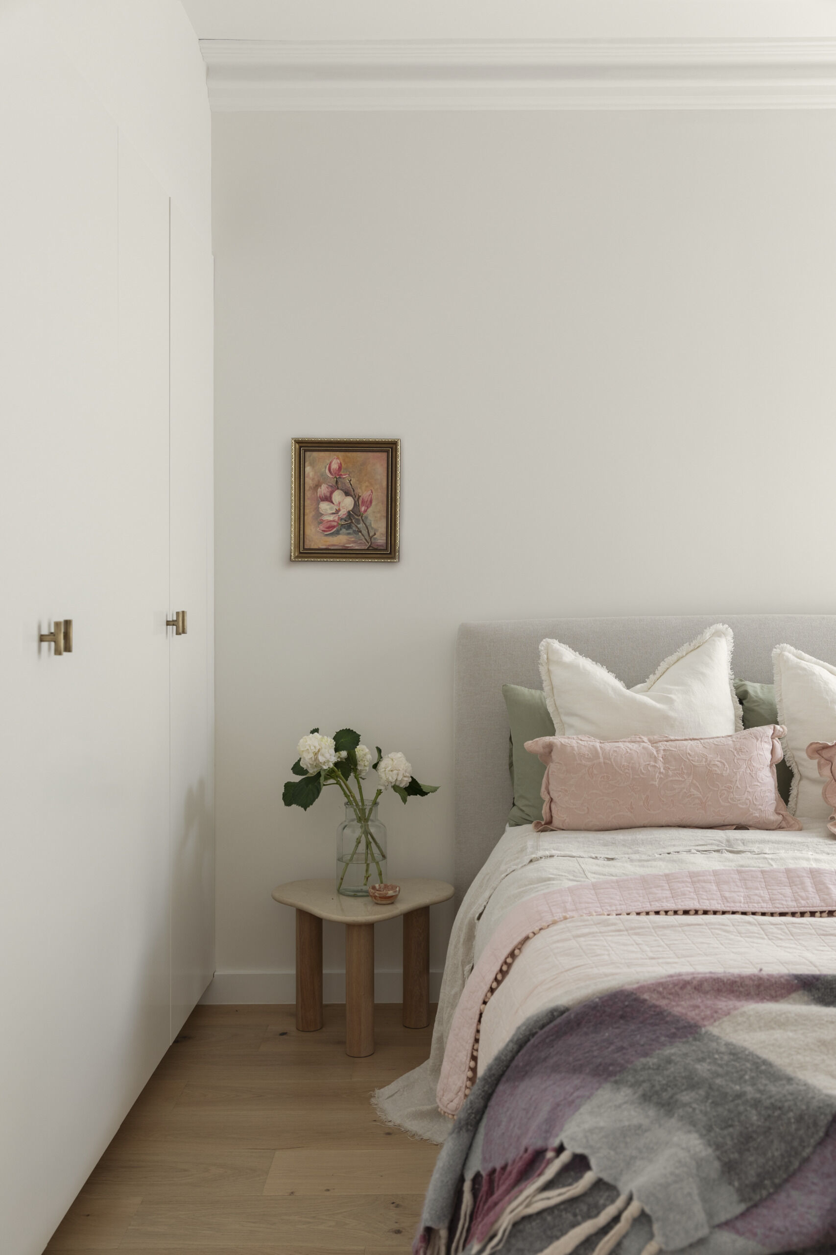 A guest bedroom with some original details, offering a quiet and practical space for visitors.