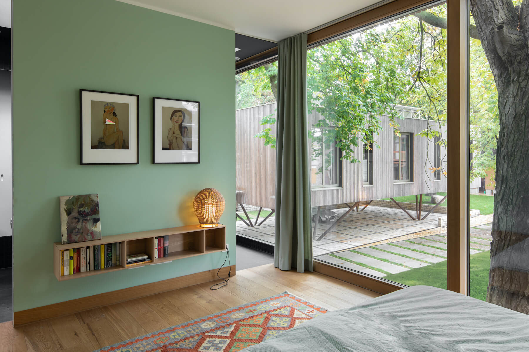 Simple bedrooms, natural light, and a clean bathroom design with a freestanding tub create a calm and comfortable private zone.