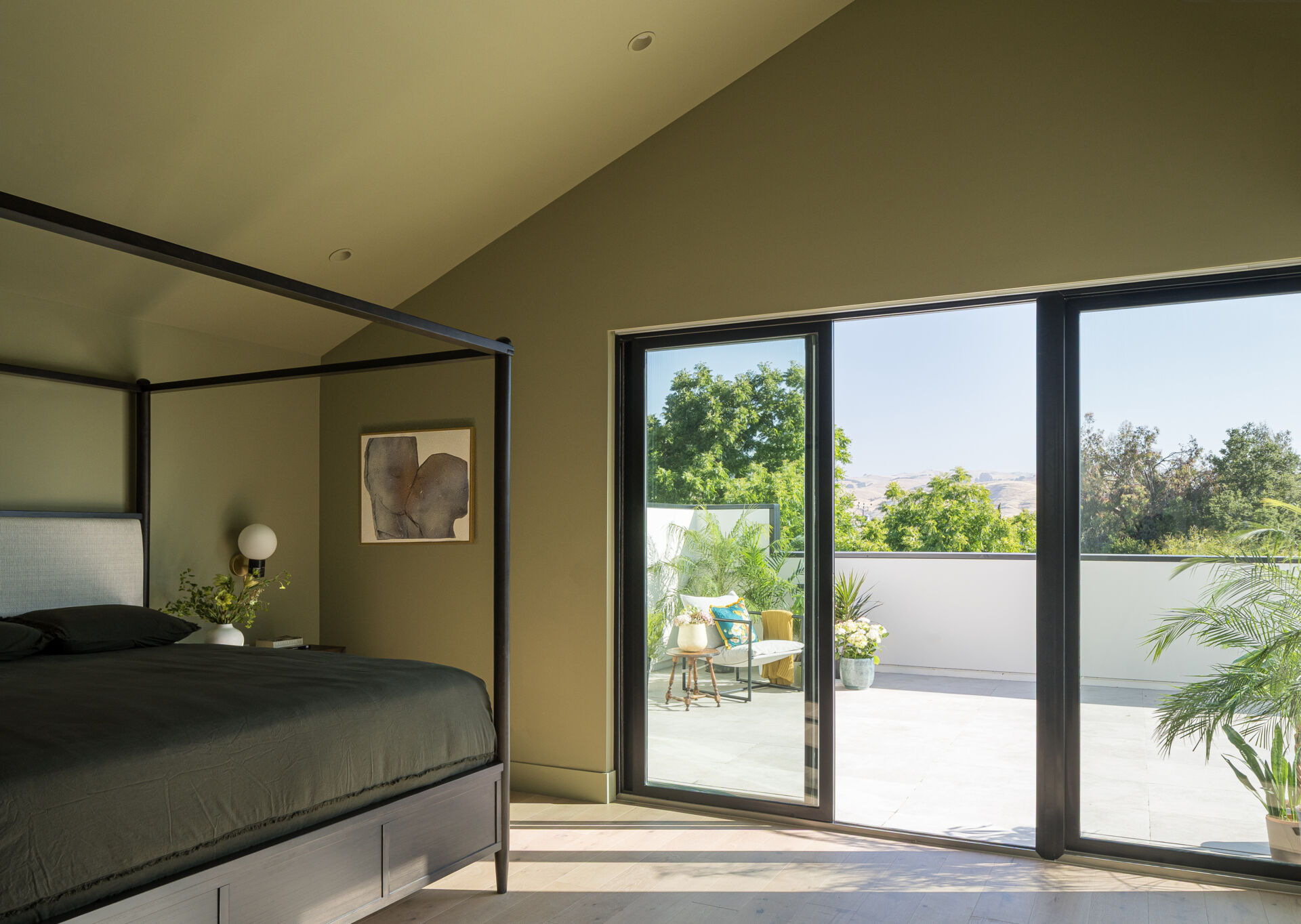 A modern and large bedroom that's open to a private patio.