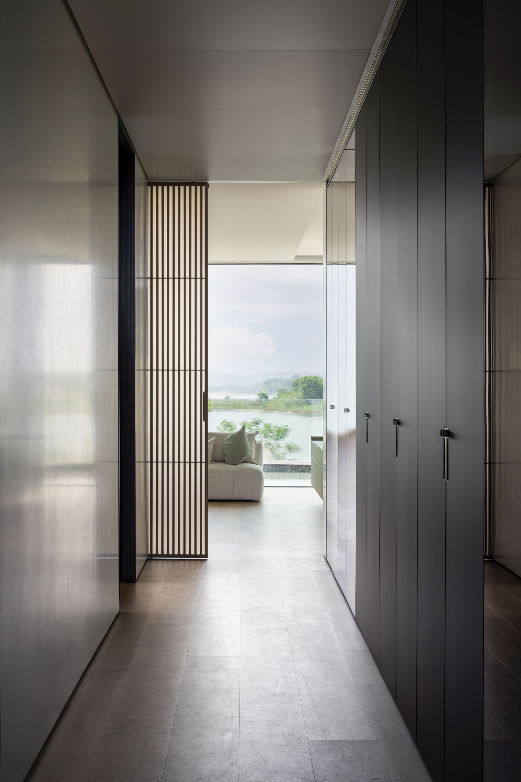 The closet continues the material-driven approach, using clean lines to create a functional yet refined space. Storage is integrated seamlessly, keeping the focus on clarity and ease of use while maintaining the same visual consistency found throughout the villa.