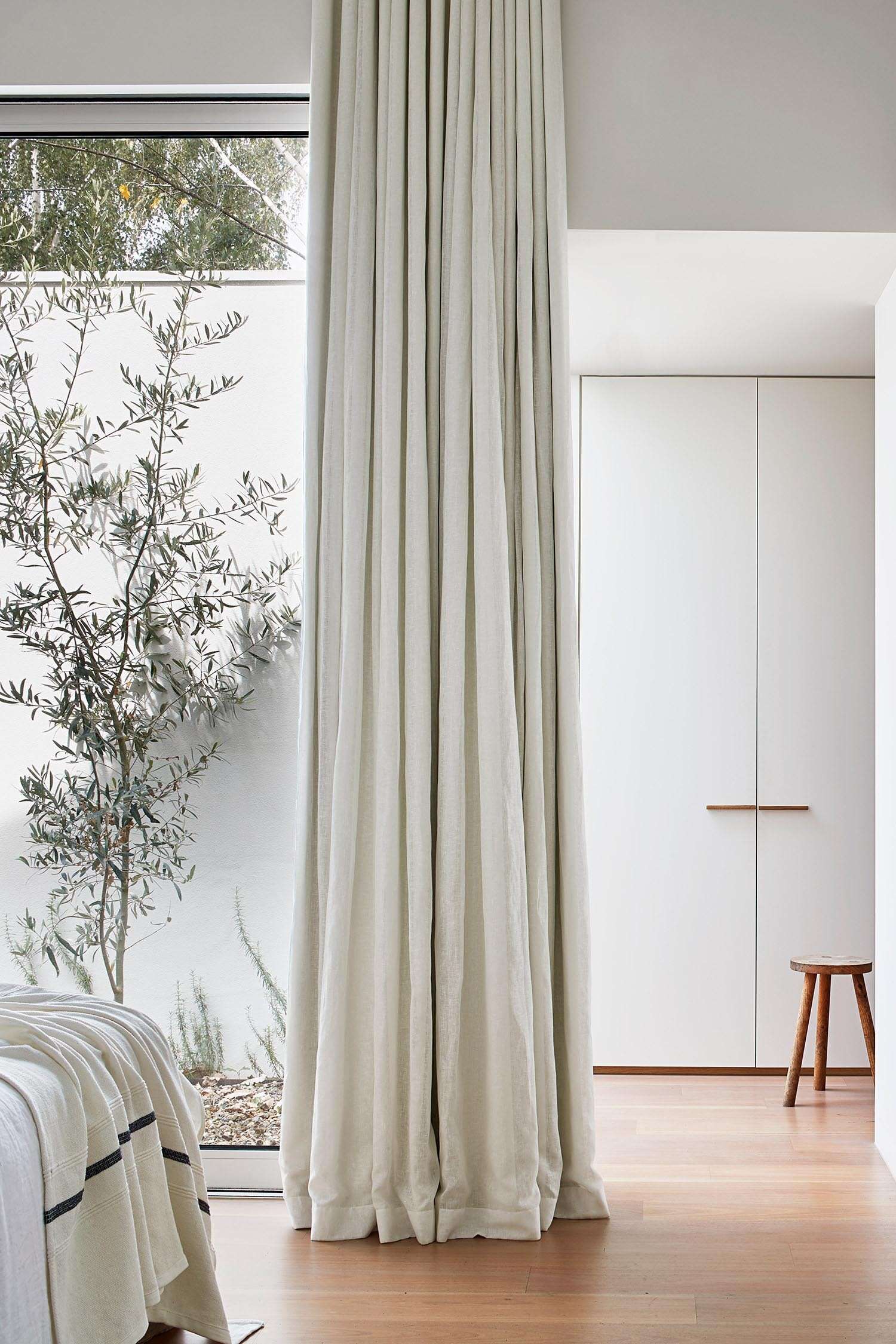 A serene bedroom with direct garden access, offering a private outdoor escape just steps from the bed.