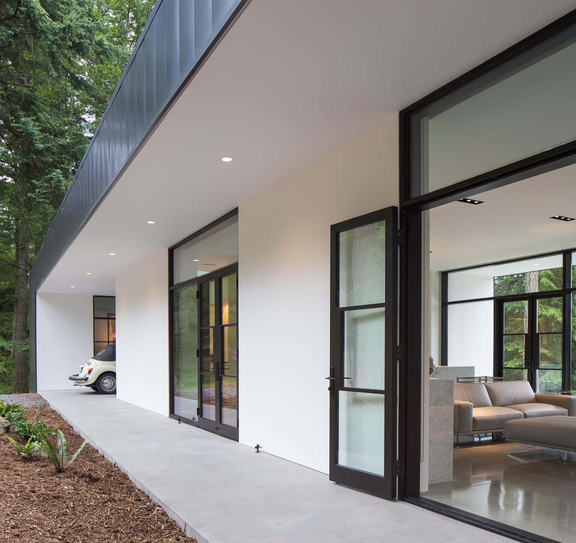 A concrete walkway and multi-use carport set the tone for this minimalist home designed with flexibility in mind.