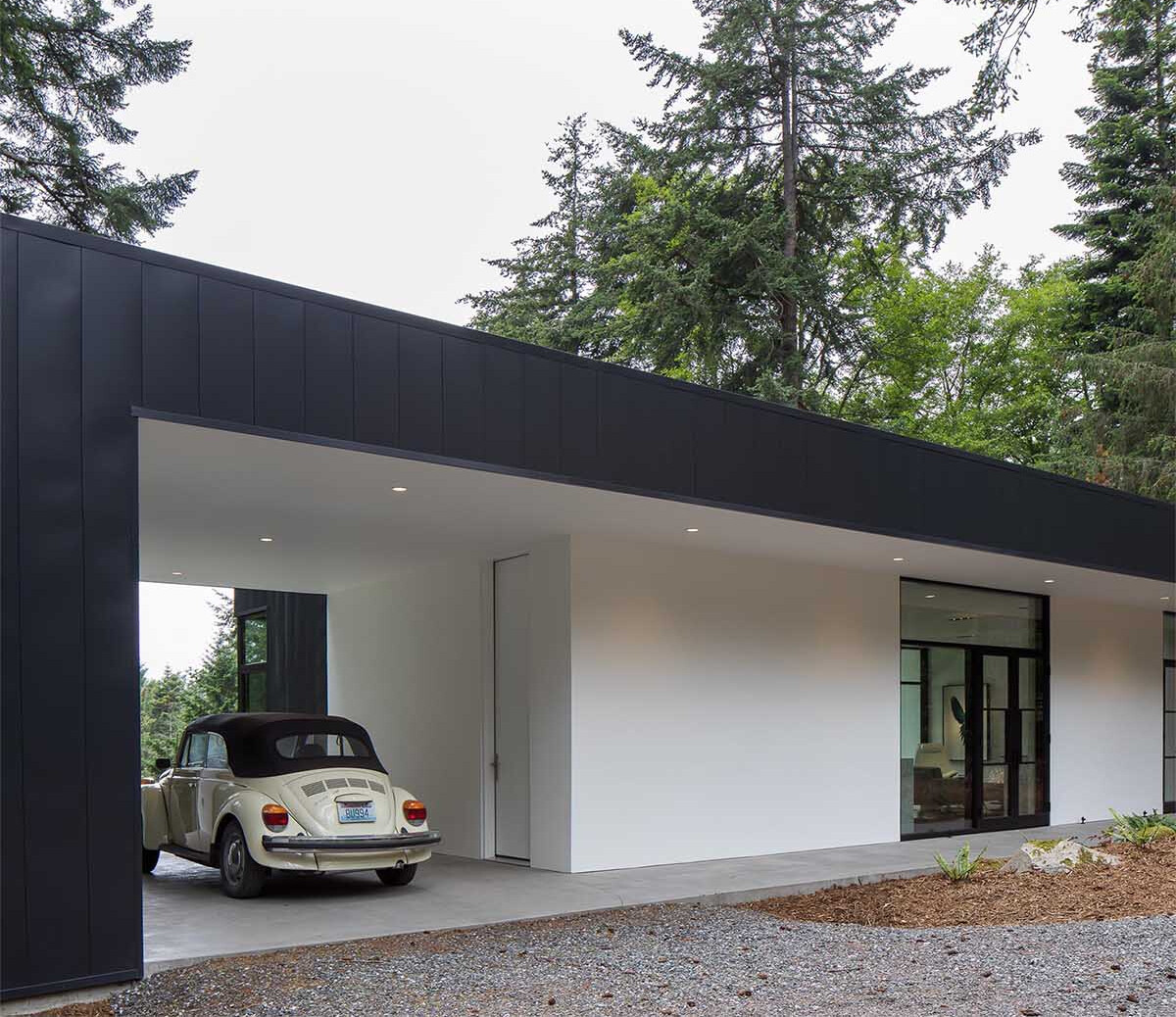 A concrete walkway and multi-use carport set the tone for this minimalist home designed with flexibility in mind.