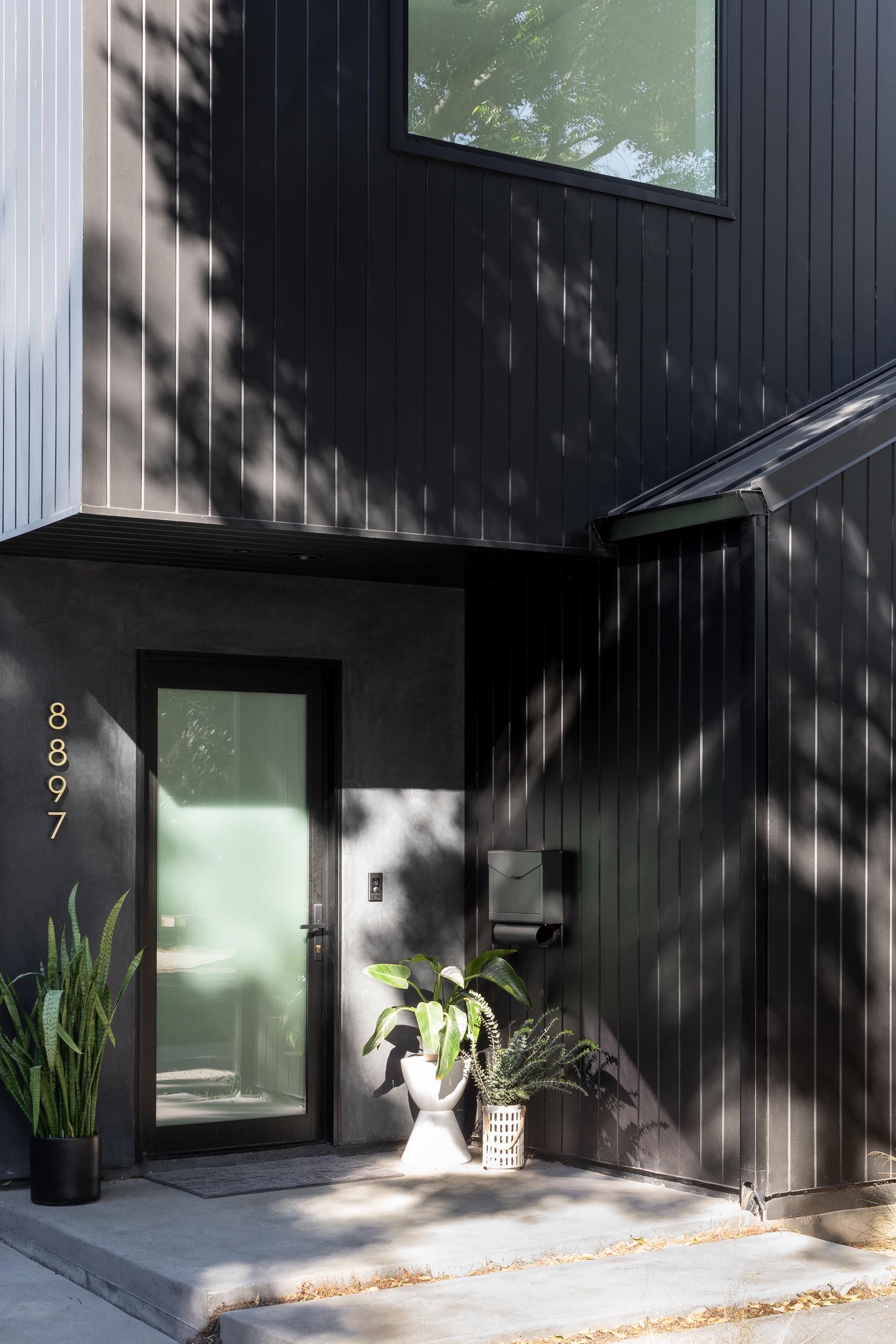 A modern black gabled home in Hermosa Beach with a sculptural exterior inspired by barn forms and Japanese design techniques.