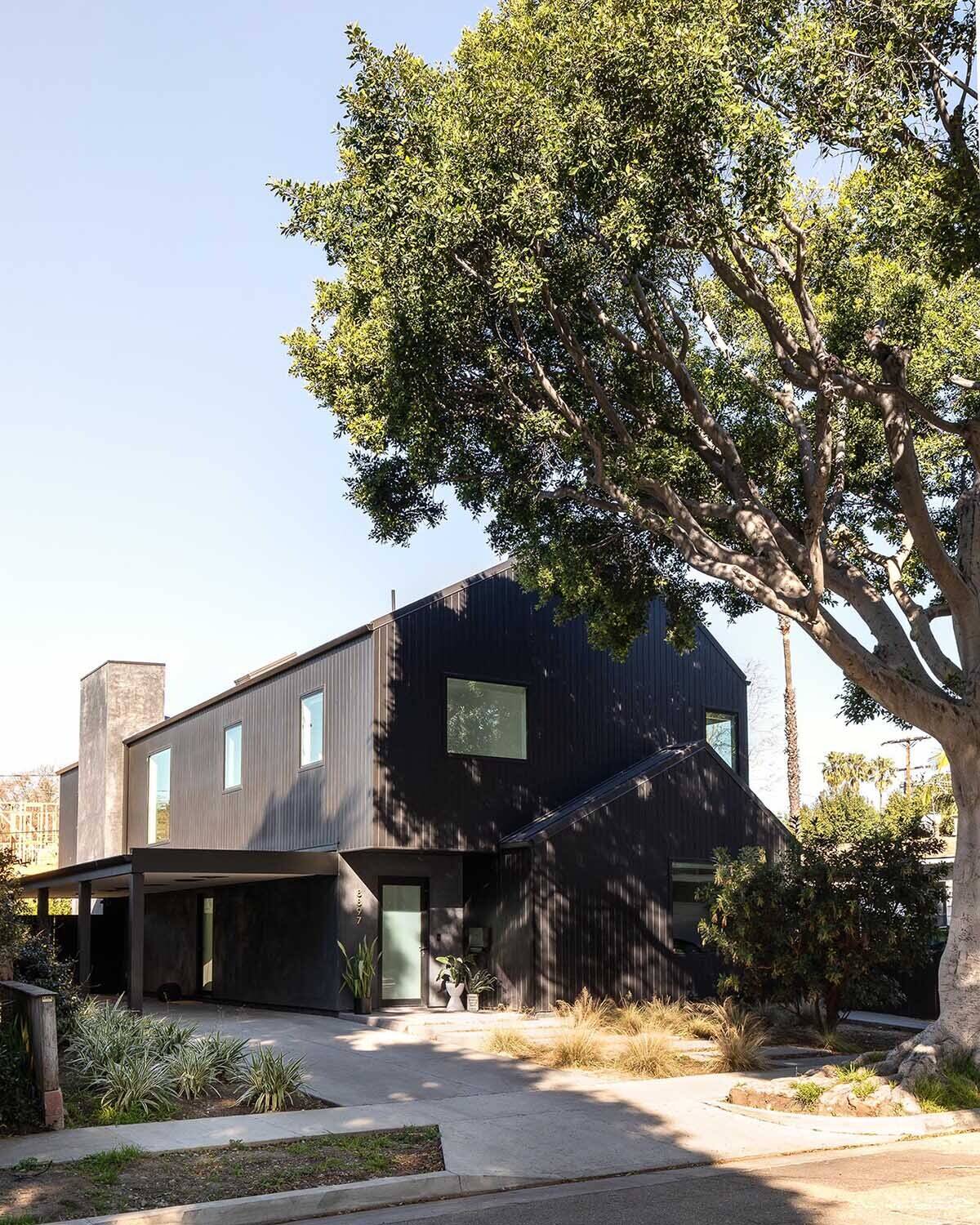 A modern black gabled home in Hermosa Beach with a sculptural exterior inspired by barn forms and Japanese design techniques.