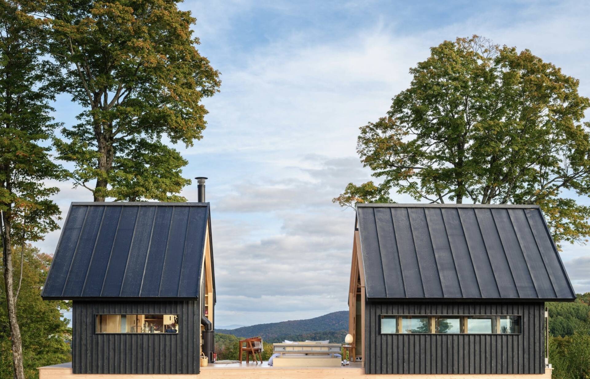 A small cabin in Vermont that physically transforms throughout the day. Cabin ANNA uses sliding timber and glass shells to create a space that can fully open to the outdoors in seconds.
