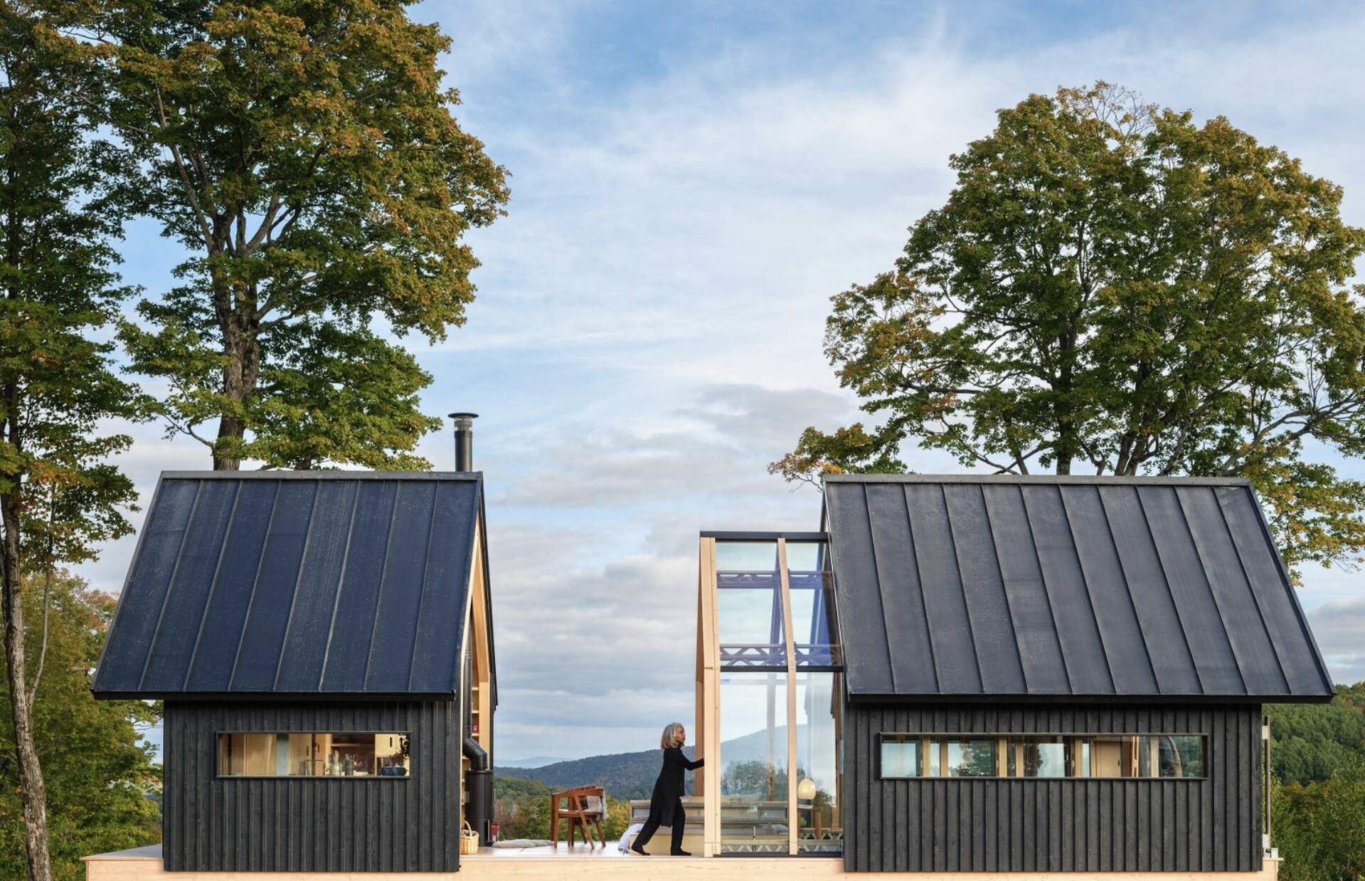 A small cabin in Vermont that physically transforms throughout the day. Cabin ANNA uses sliding timber and glass shells to create a space that can fully open to the outdoors in seconds.