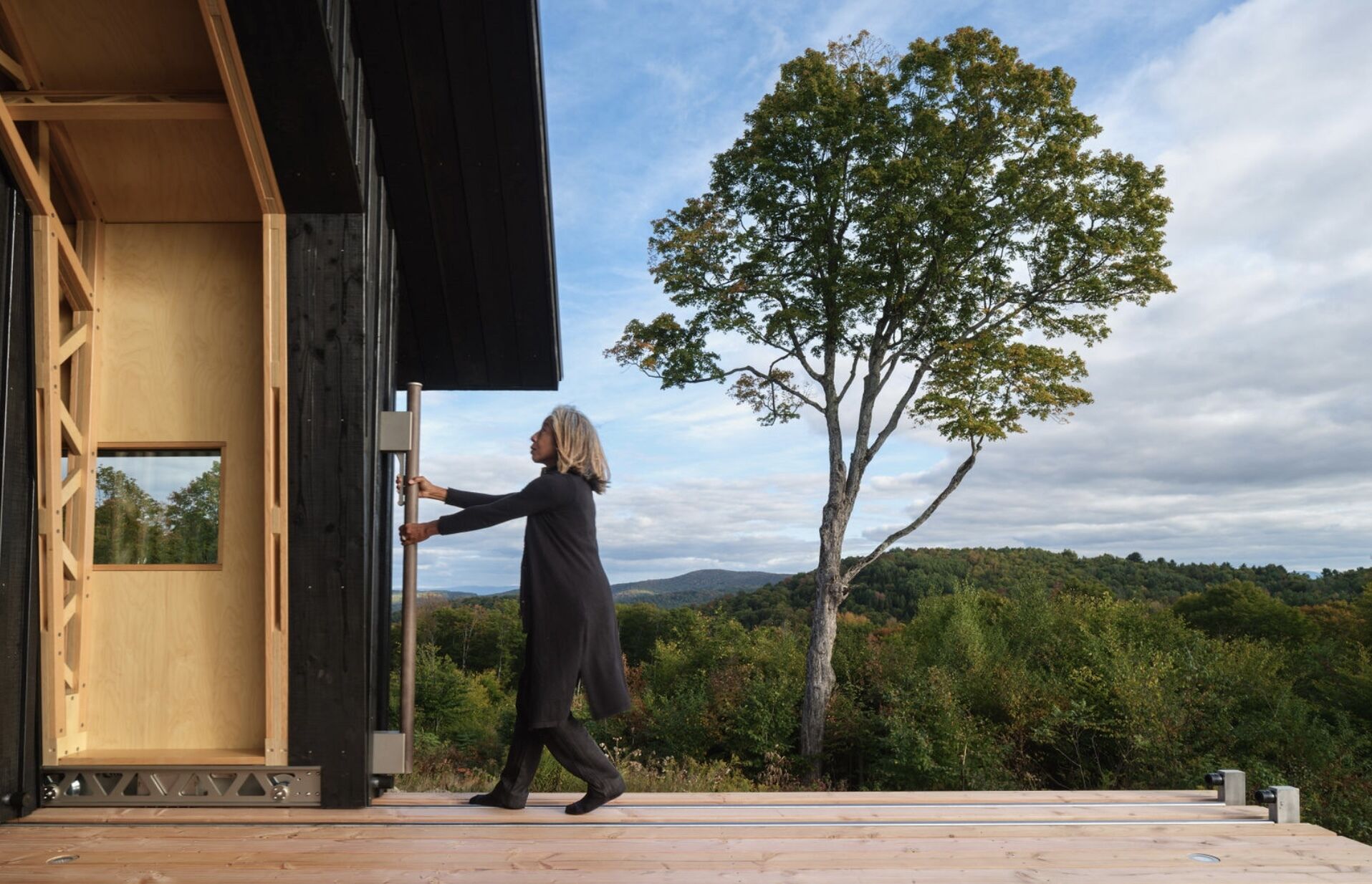 A small cabin in Vermont that physically transforms throughout the day. Cabin ANNA uses sliding timber and glass shells to create a space that can fully open to the outdoors in seconds.