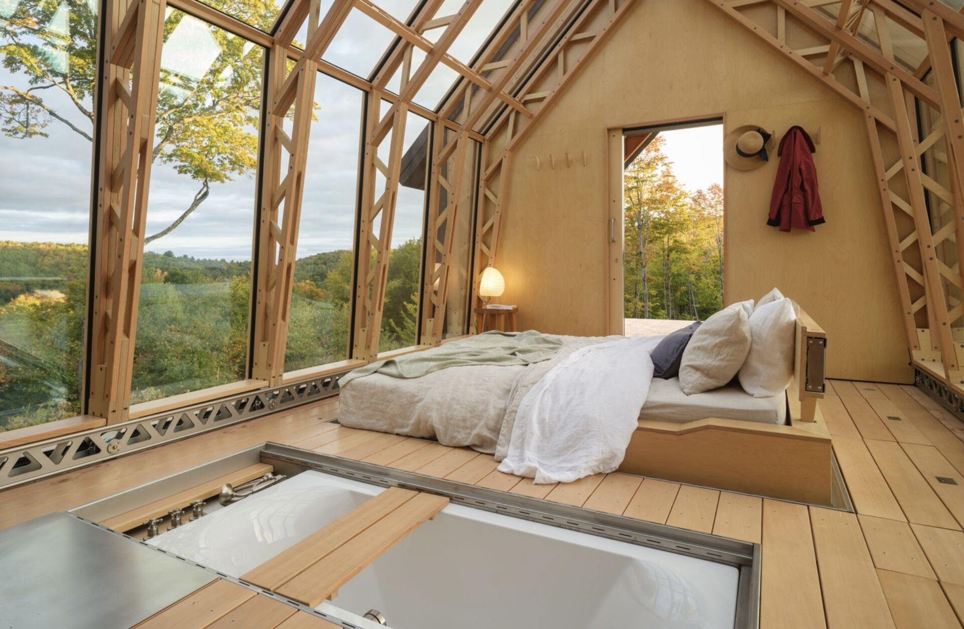 A small cabin in Vermont that physically transforms throughout the day. Cabin ANNA uses sliding timber and glass shells to create a space that can fully open to the outdoors in seconds.