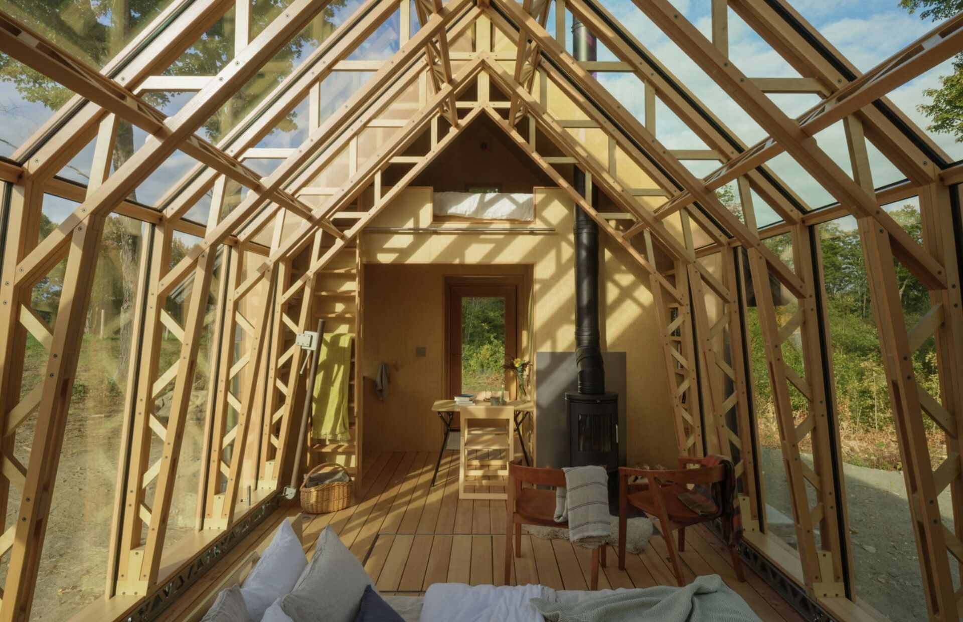 A small cabin in Vermont that physically transforms throughout the day. Cabin ANNA uses sliding timber and glass shells to create a space that can fully open to the outdoors in seconds.