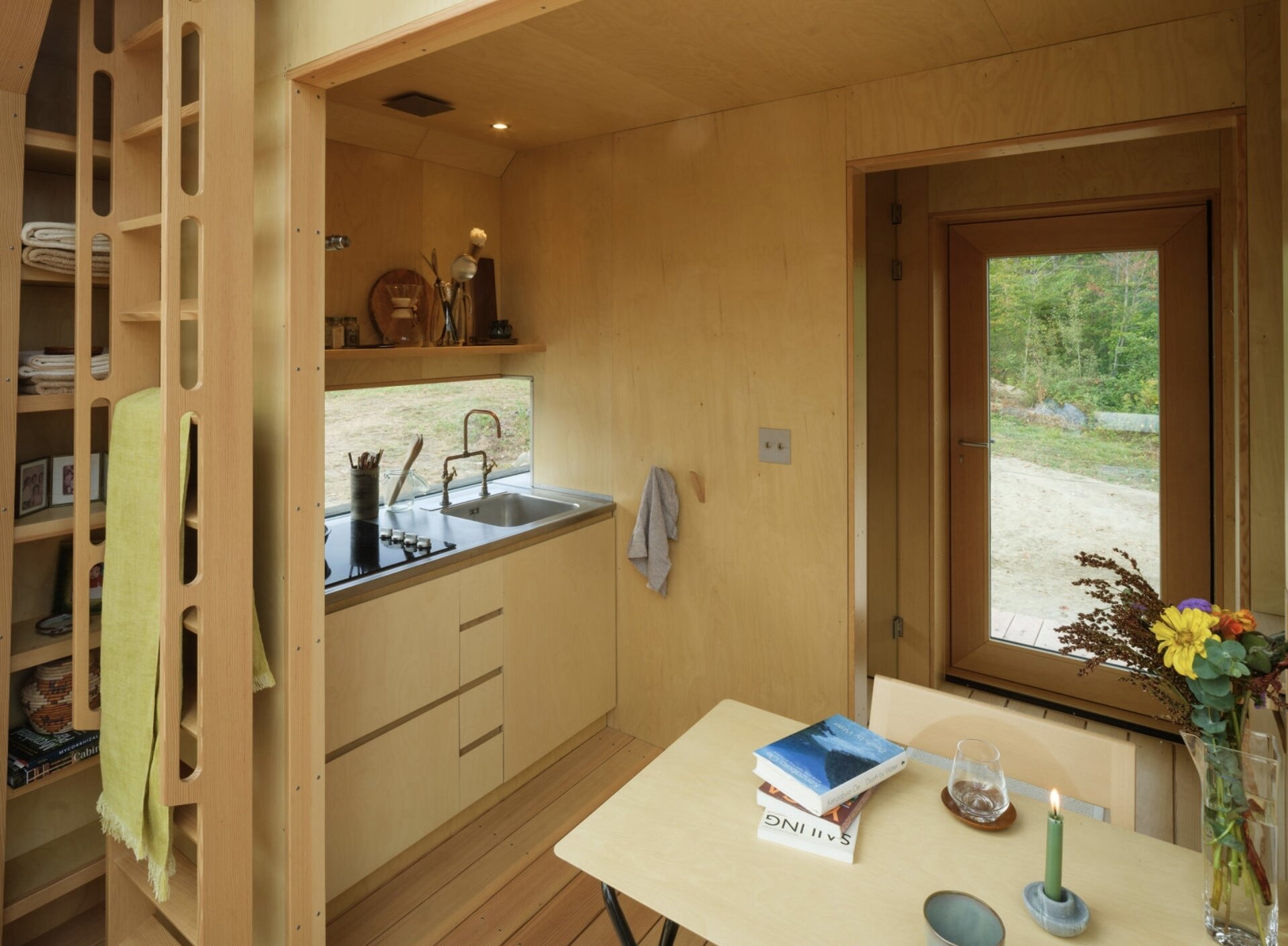 A small cabin in Vermont that physically transforms throughout the day. Cabin ANNA uses sliding timber and glass shells to create a space that can fully open to the outdoors in seconds.