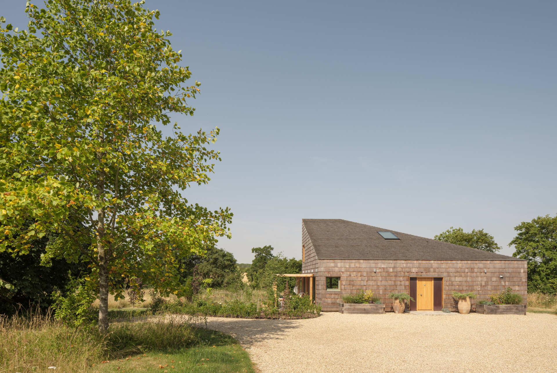 Western red cedar shingles wrap this wedge house, creating a warm exterior that will age beautifully over time.