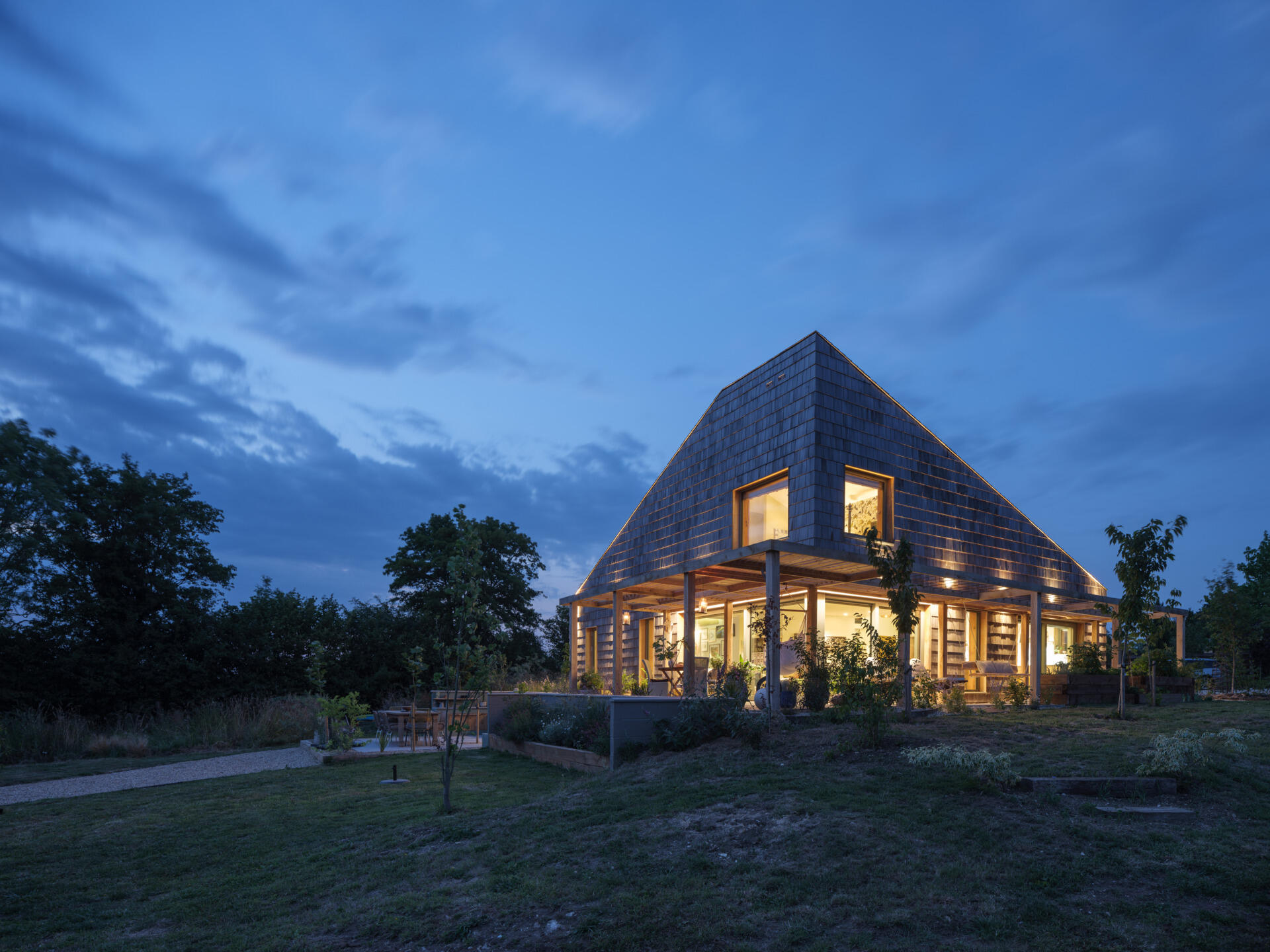 Western red cedar shingles wrap this wedge house, creating a warm exterior that will age beautifully over time.