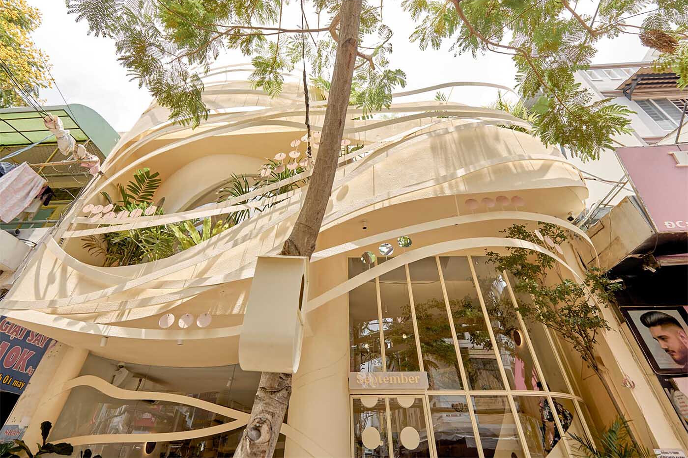 Ribbon-like steel wraps this café facade, creating a woven, nest-inspired look full of curves and depth.