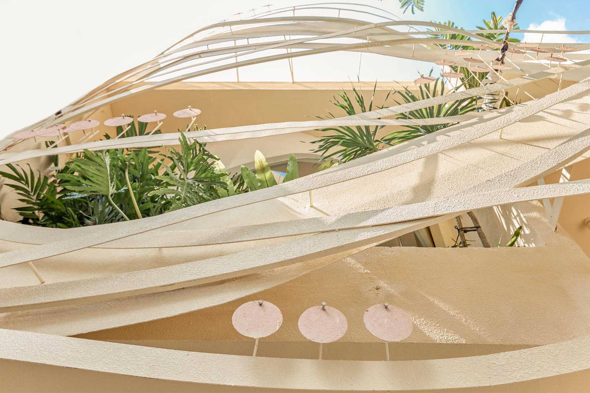 Ribbon-like steel wraps this café facade, creating a woven, nest-inspired look full of curves and depth.