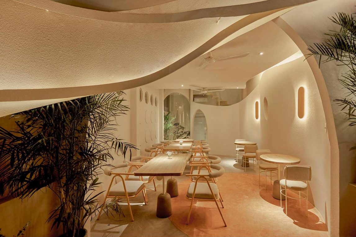 An open-air café level with circular design details and neighborhood views adds a unique outdoor experience.