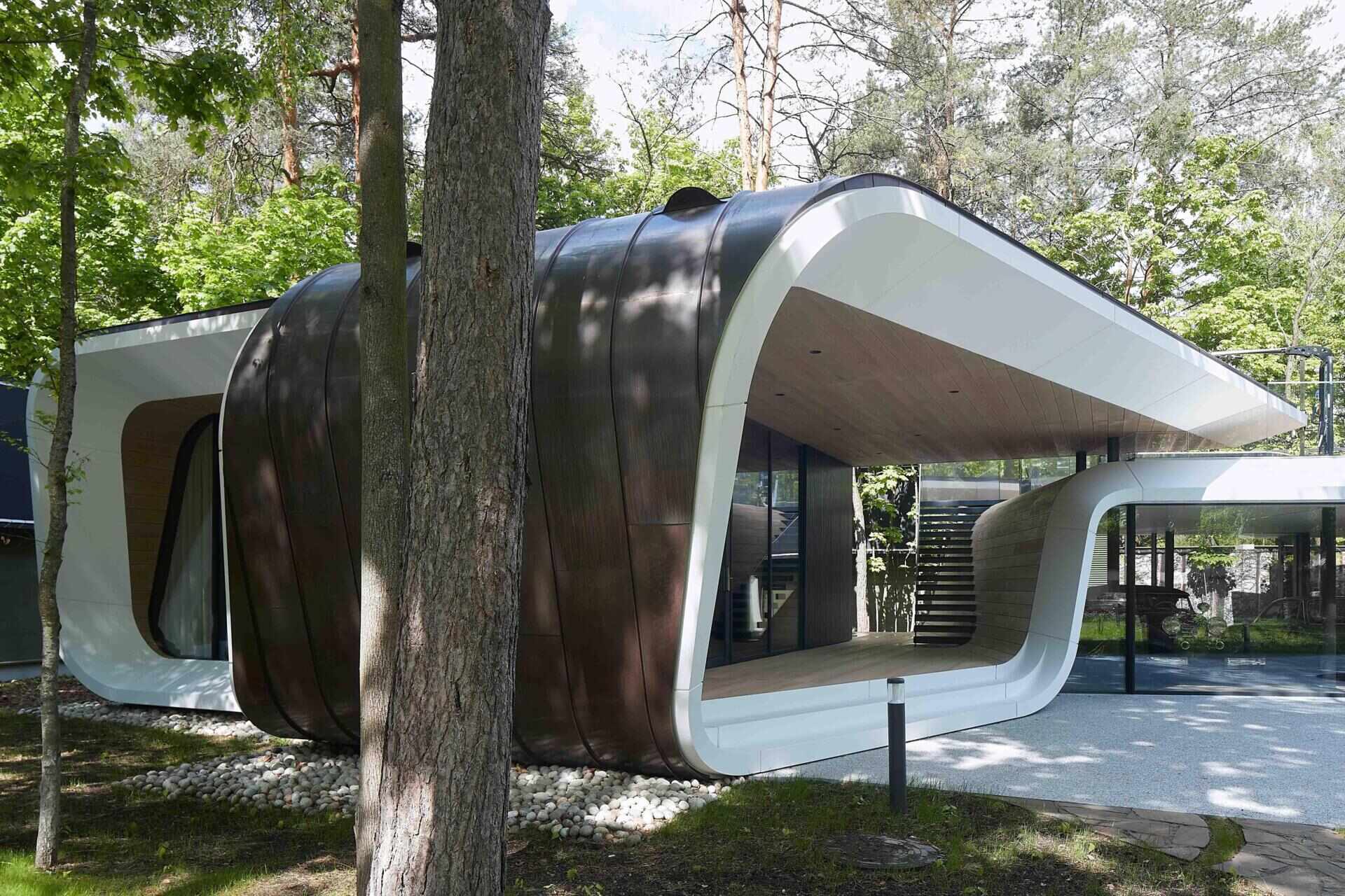 A modern garage by ATRIUM expands a private estate, turning car storage into a striking architectural feature in a forest setting.