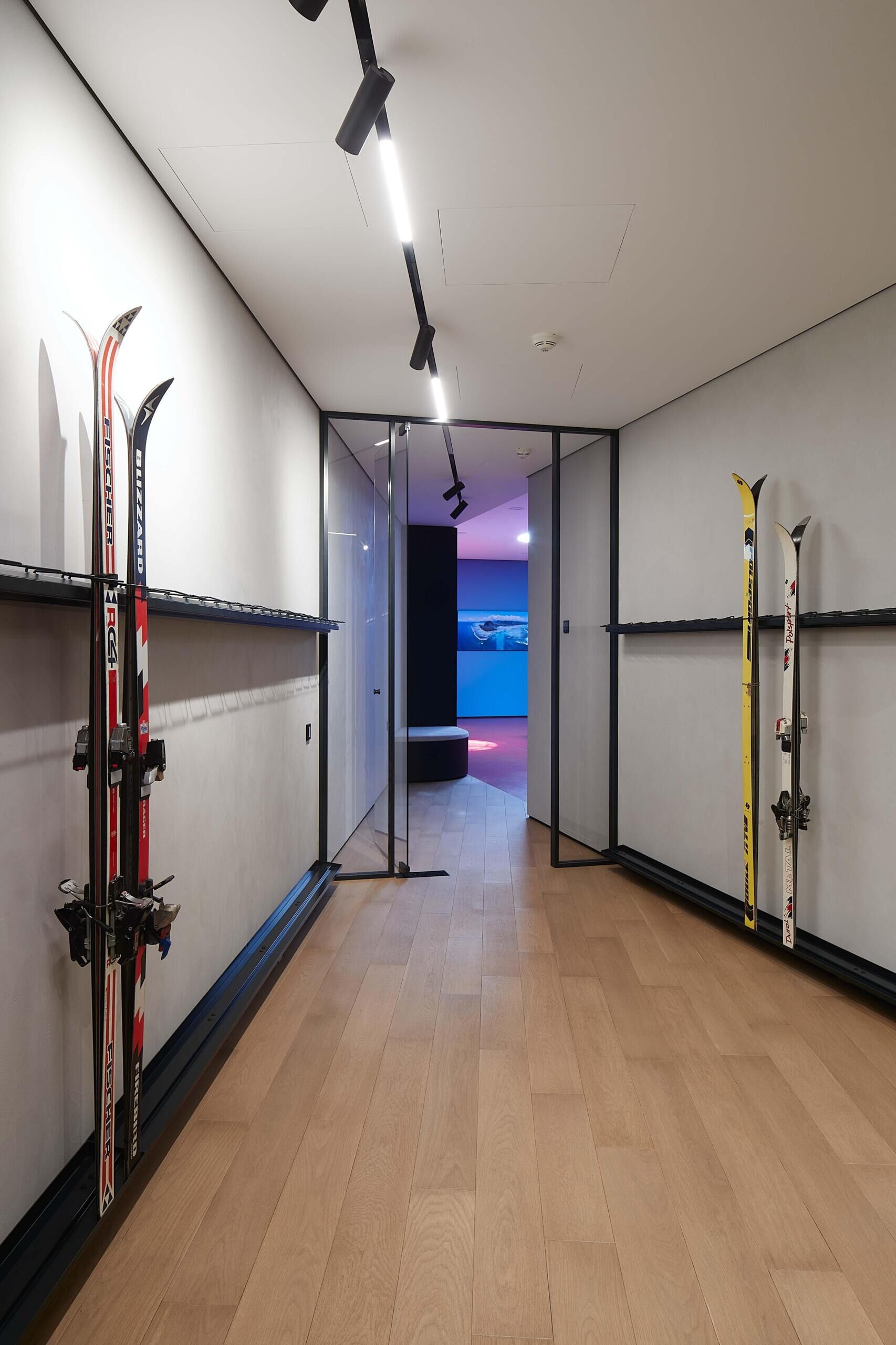 A modern garage by ATRIUM expands a private estate, turning car storage into a striking architectural feature in a forest setting.