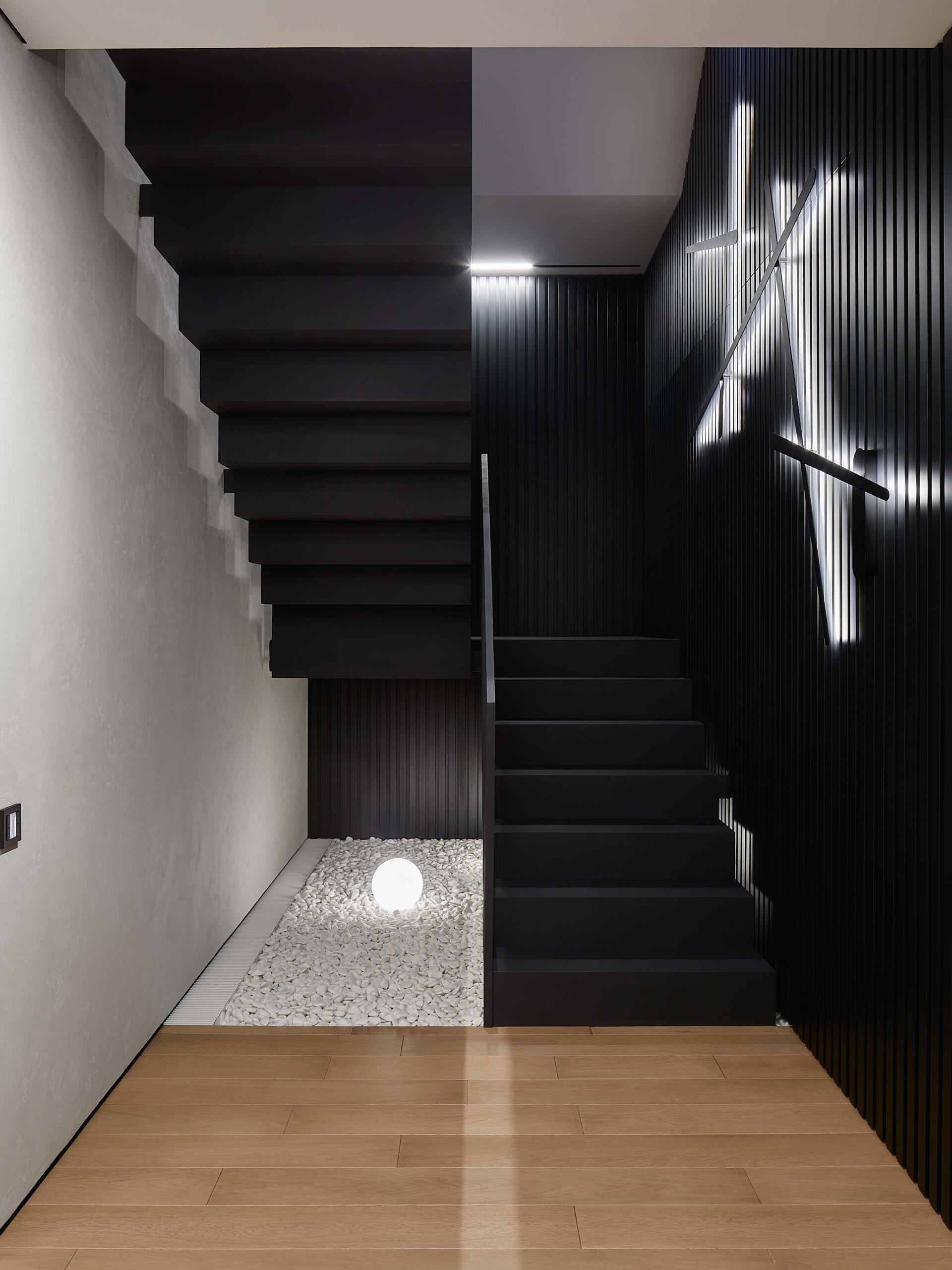 A modern garage by ATRIUM expands a private estate, turning car storage into a striking architectural feature in a forest setting.