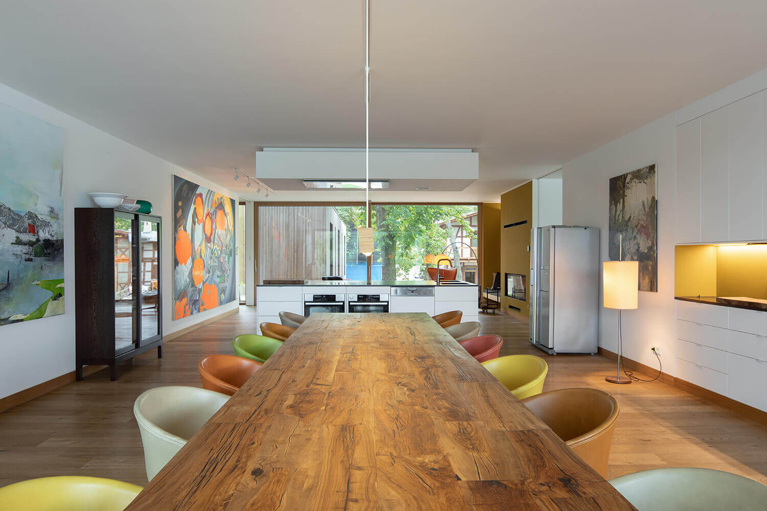 A minimalist kitchen with a white island and dark countertop delivers a clean, modern look with practical functionality.