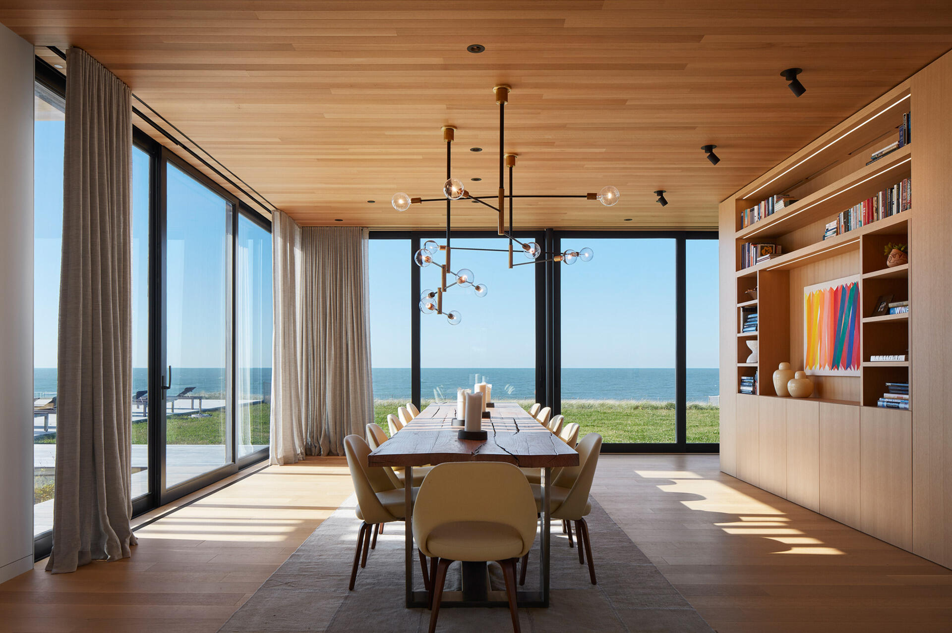 A dining room with uninterrupted lake views brings natural light and scenery into every meal.