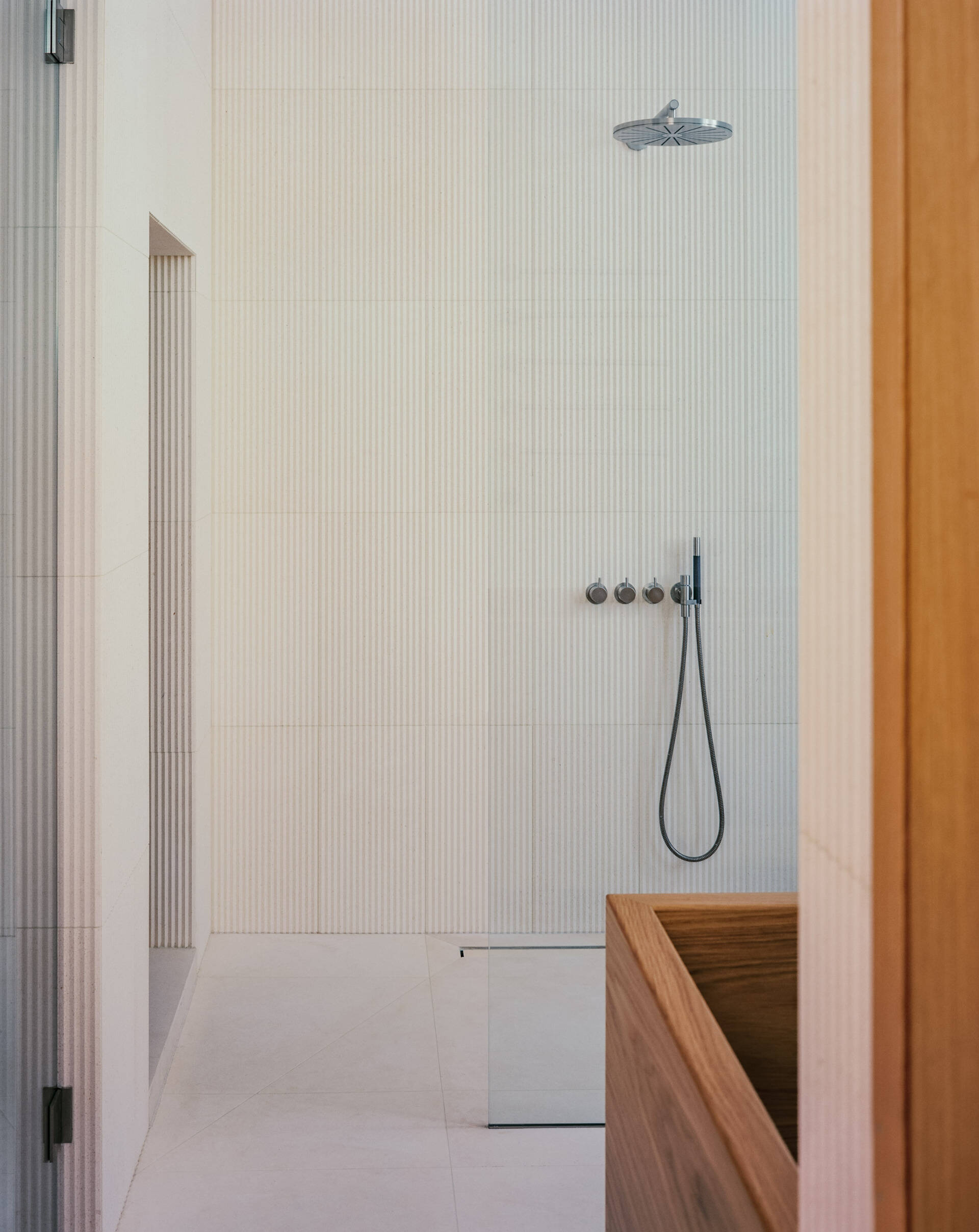 A private bedroom suite with an integrated office and a deep wood soaking tub blends function with standout design.