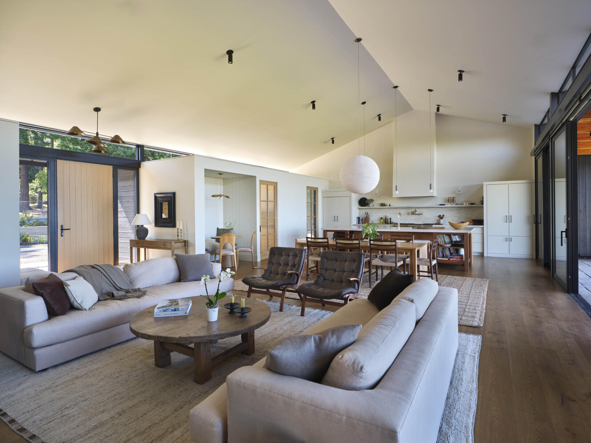Inside, the living area is open, bright, and directly connected to the outdoors. Large sliding glass doors lead to a covered patio, making it easy to move between inside and out in any season. 