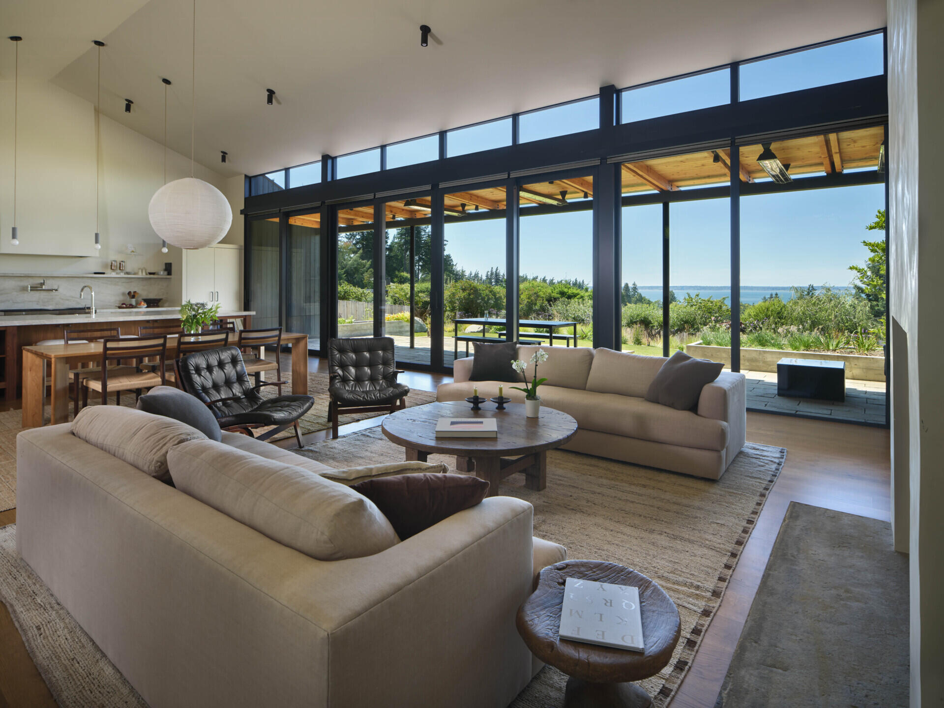 An open living space with large sliding doors connects directly to a covered patio for easy indoor-outdoor flow.