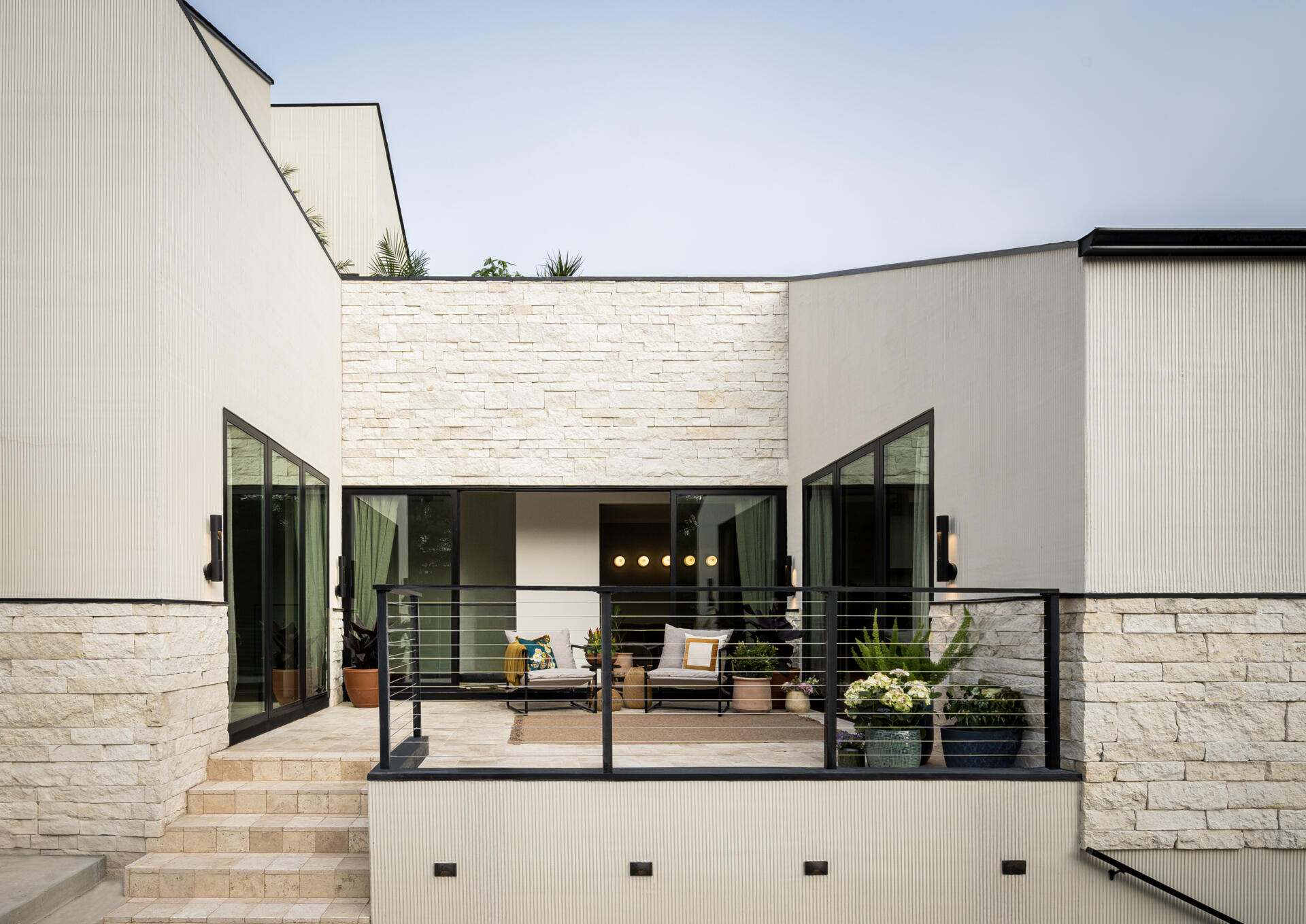 Positioned between key living spaces, this patio acts as a connector. It draws daylight deeper into the home and creates an easy transition between indoors and outdoors, reinforcing how the house opens up despite its tight surroundings.