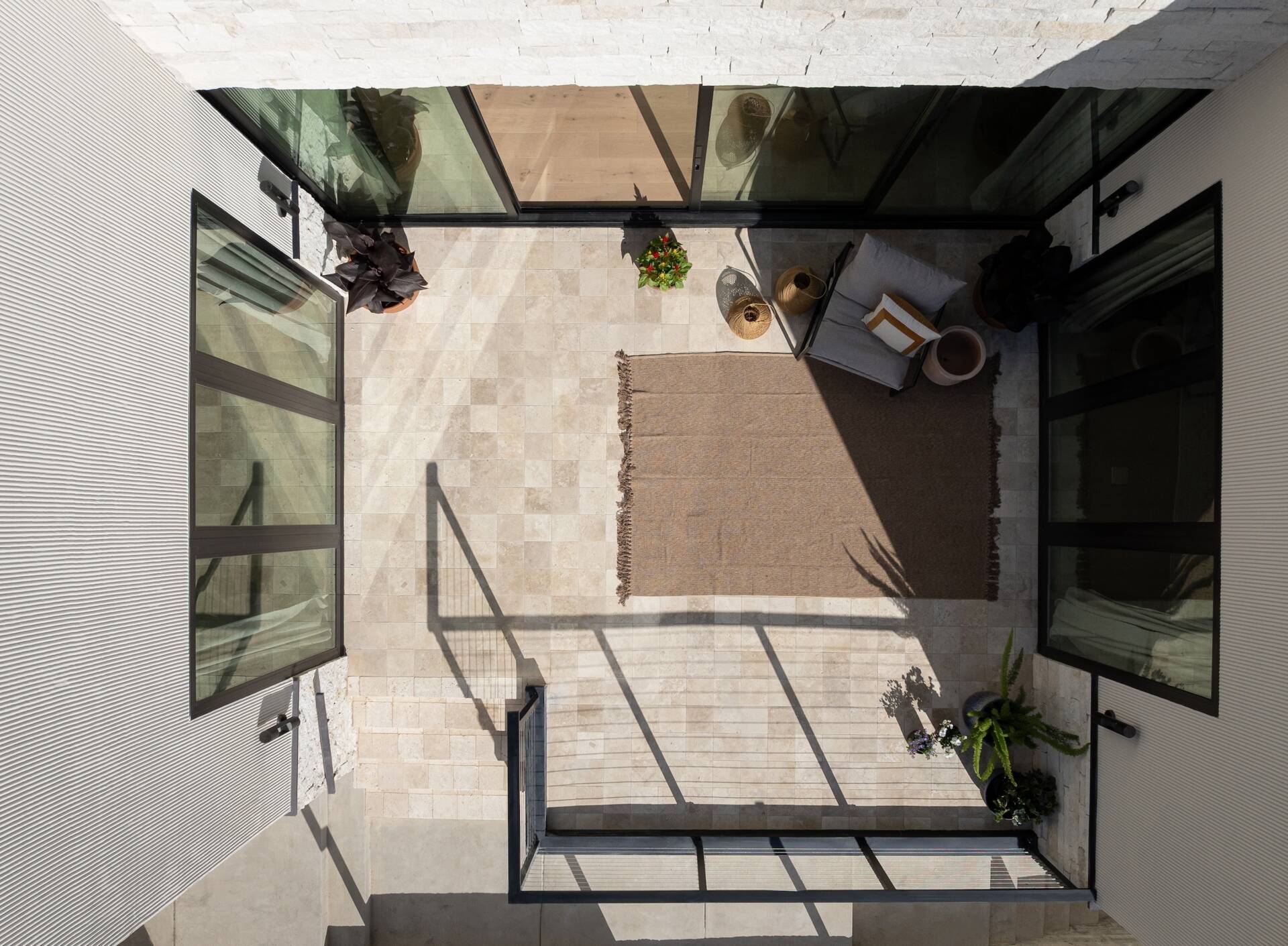 Positioned between key living spaces, this patio acts as a connector. It draws daylight deeper into the home and creates an easy transition between indoors and outdoors, reinforcing how the house opens up despite its tight surroundings.