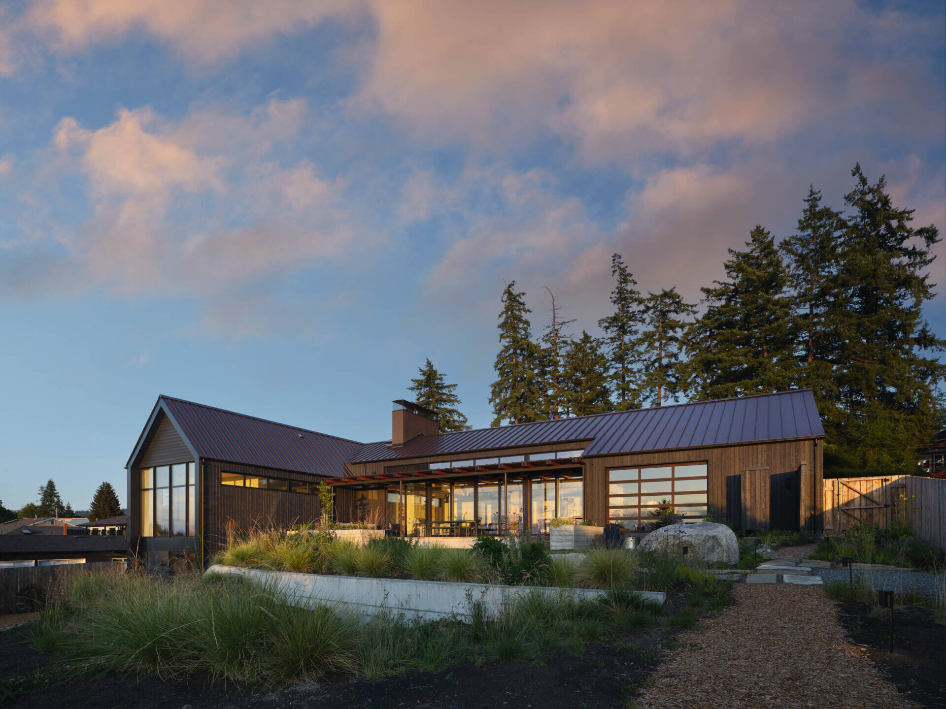 Charred wood siding and a standing seam metal roof create a durable, low-maintenance exterior for this modern home with rich texture.