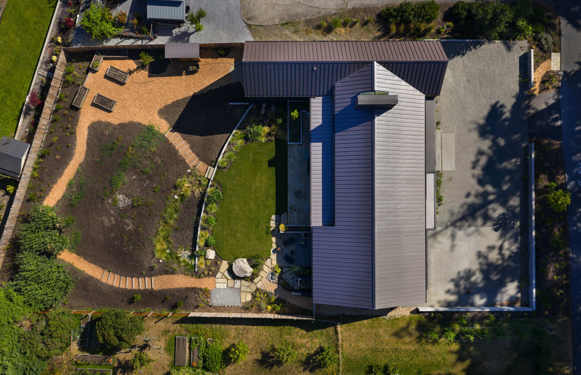 Charred wood siding and a standing seam metal roof create a durable, low-maintenance exterior for this modern home with rich texture.